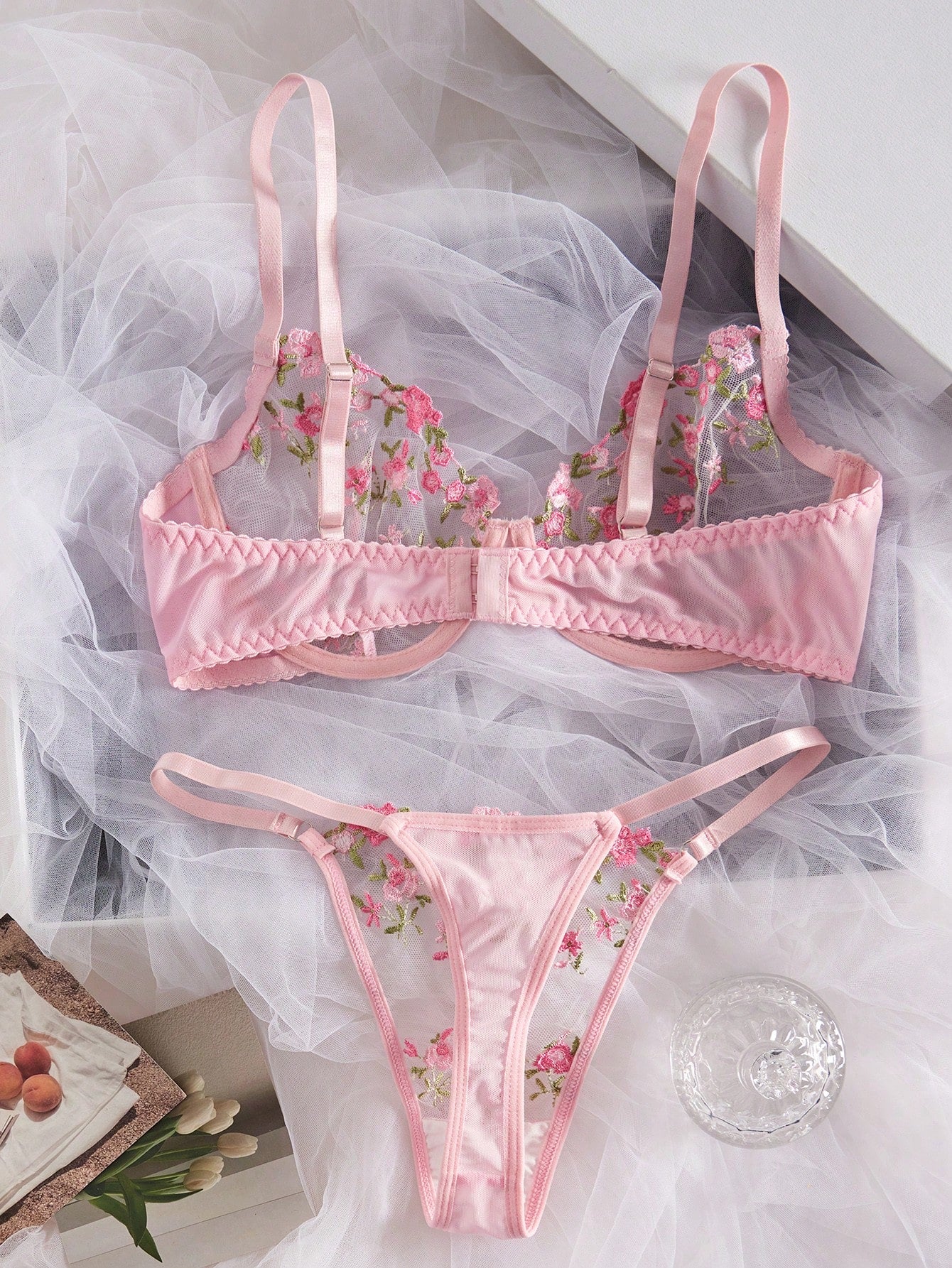 Women's floral embroidered sheer mesh lingerie set featuring a spaghetti strap camisole-style bralette with adjustable straps and a matching low-rise thong.