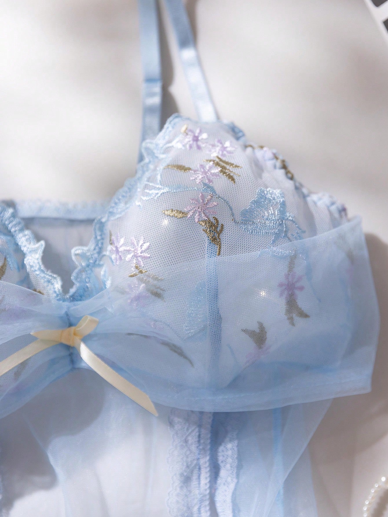 Baby blue 2-piece women’s lingerie set featuring a sheer embroidered camisole-style nightgown with adjustable spaghetti straps and a matching low-rise thong panty.