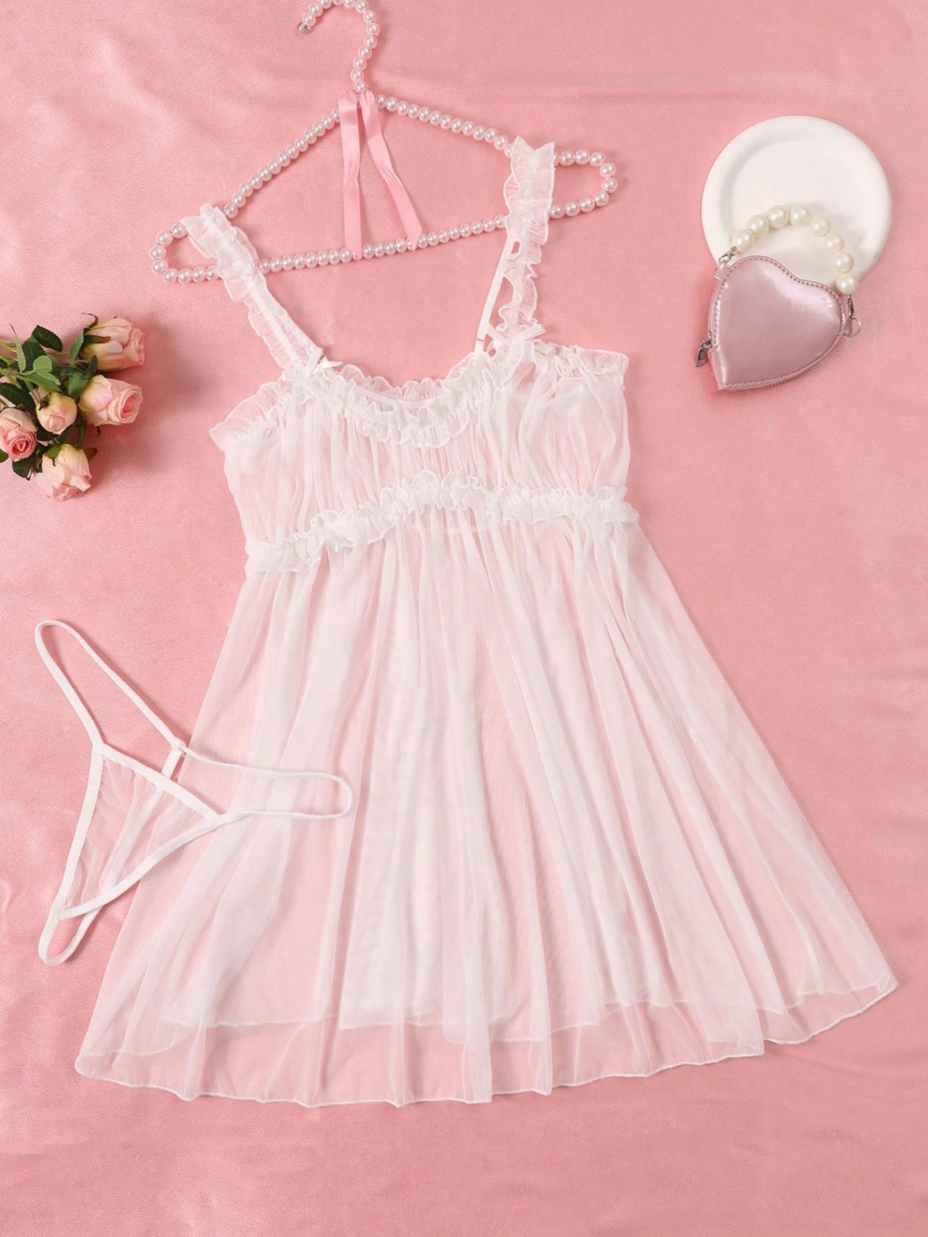 Women’s semi-sheer mini slip nightgown with adjustable spaghetti straps, sweetheart neckline, contrast lace, bow and frill details, and a matching low-rise V-string in a 2-piece set.