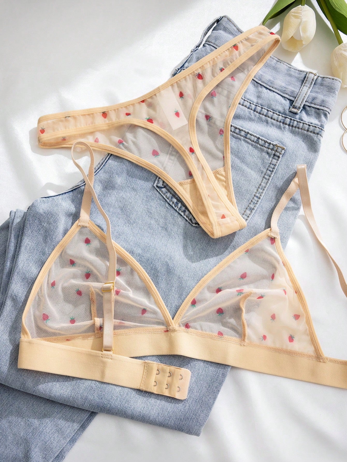 Women’s 2-piece lingerie set featuring a wireless bralette and matching low-rise G-string thong with adjustable straps, contrast binding, and an all-over multicolor animal-inspired print.