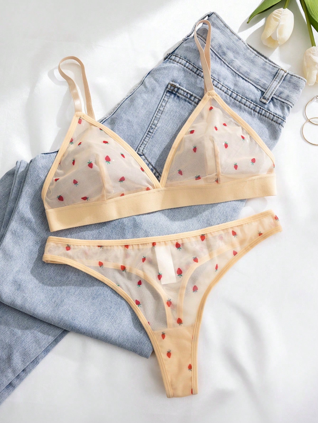 Women’s 2-piece lingerie set featuring a wireless bralette and matching low-rise G-string thong with adjustable straps, contrast binding, and an all-over multicolor animal-inspired print.