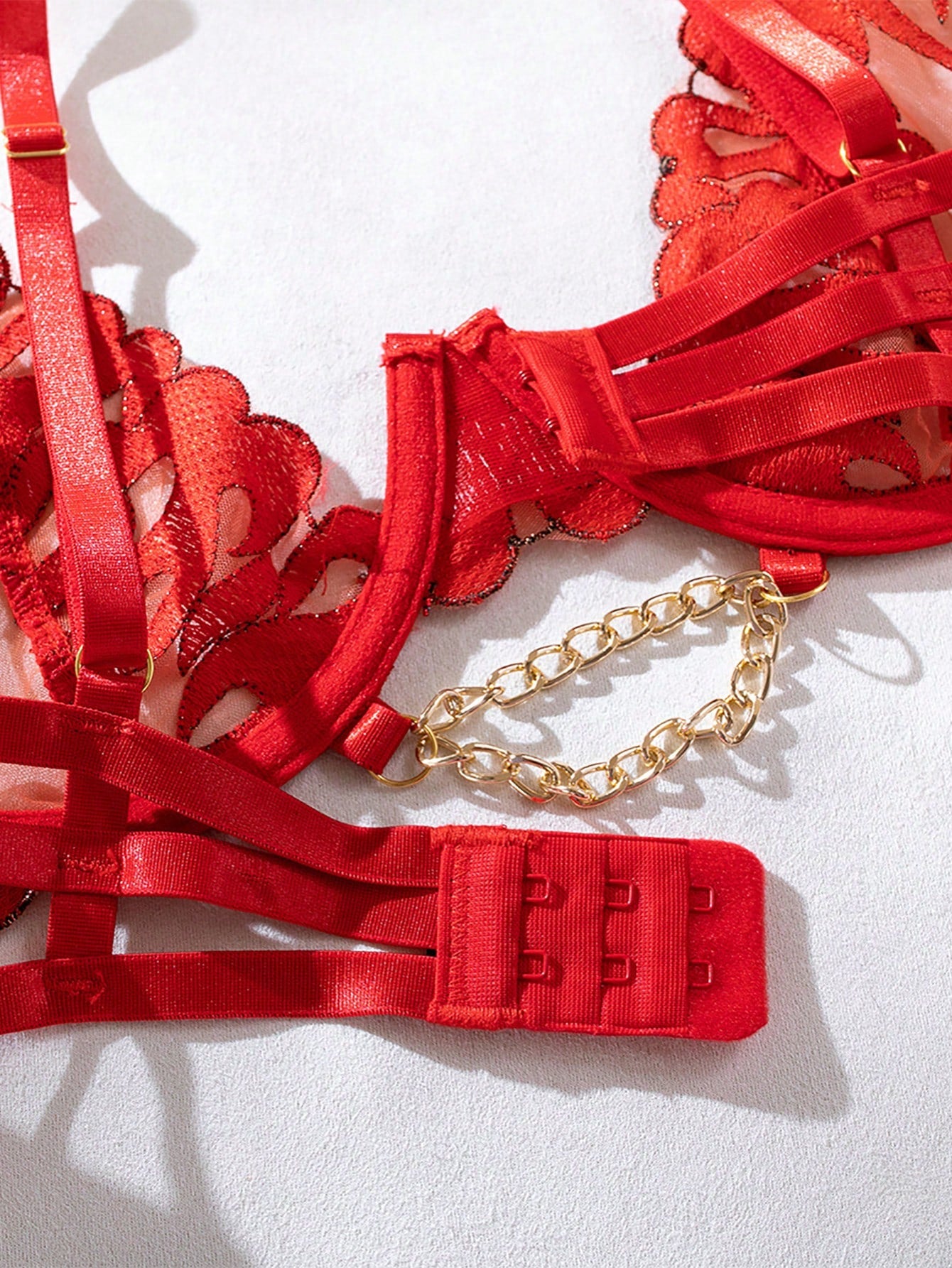 Red 5-piece bridal lingerie set with random floral flame embroidery, sheer details, chain accents, adjustable spaghetti straps, underwire bralette, and low-rise thong pieces.