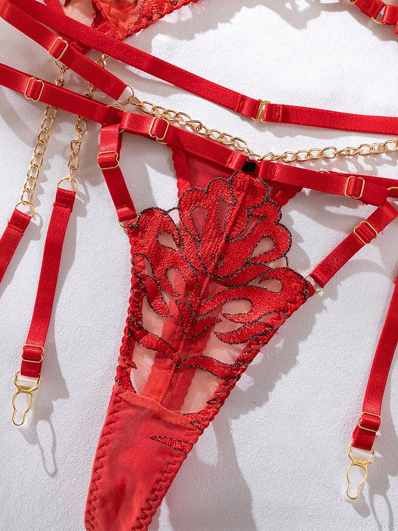 Red 5-piece bridal lingerie set with random floral flame embroidery, sheer details, chain accents, adjustable spaghetti straps, underwire bralette, and low-rise thong pieces.