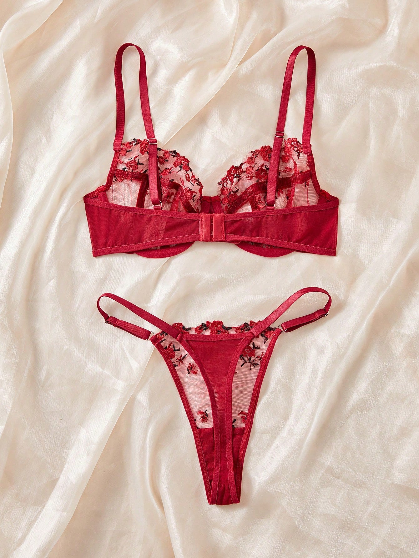 Women's black and red embroidered sheer lingerie set featuring an underwire bra with adjustable straps and a matching low-rise thong, 2-piece set.