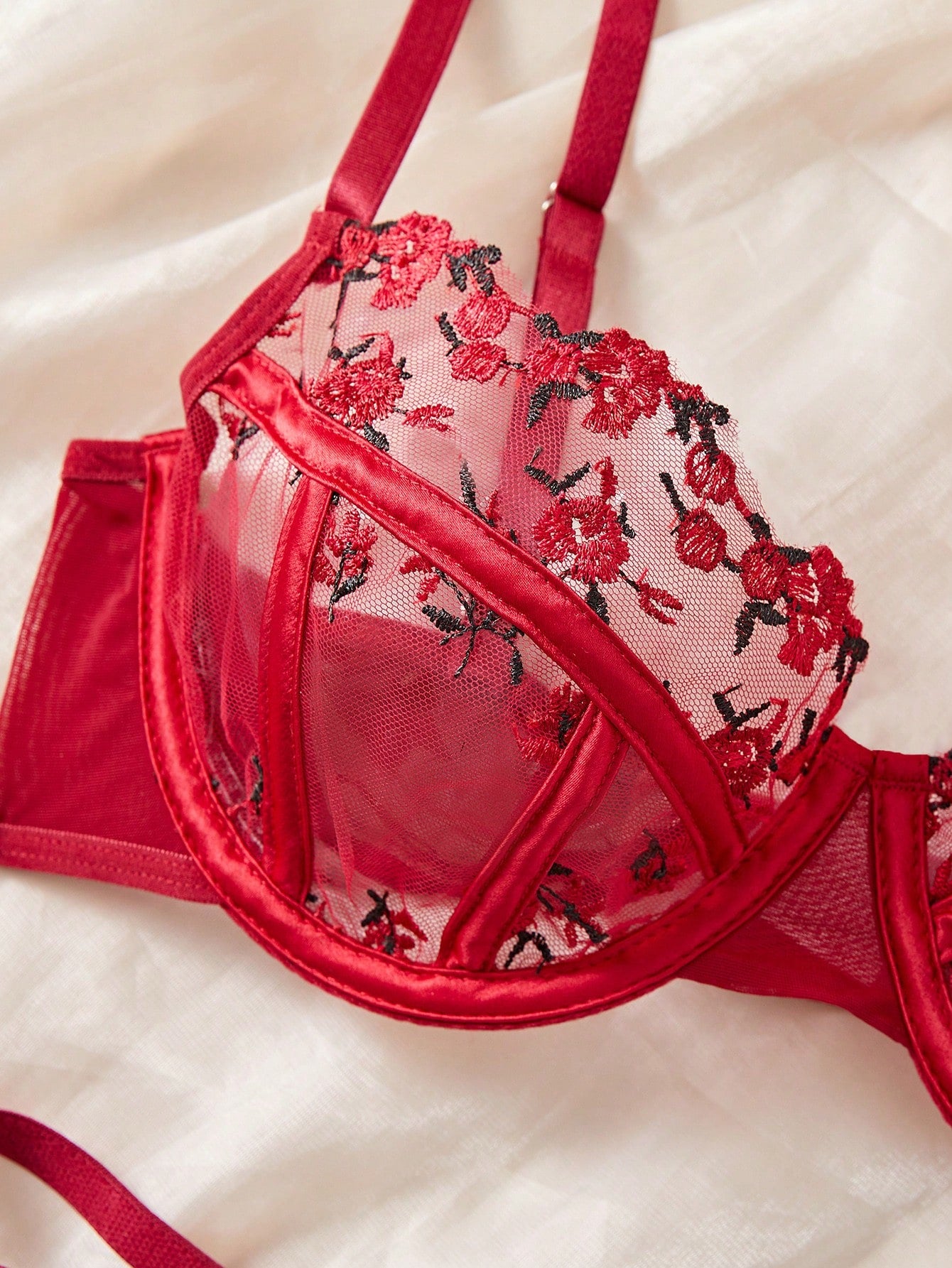 Women's black and red embroidered sheer lingerie set featuring an underwire bra with adjustable straps and a matching low-rise thong, 2-piece set.