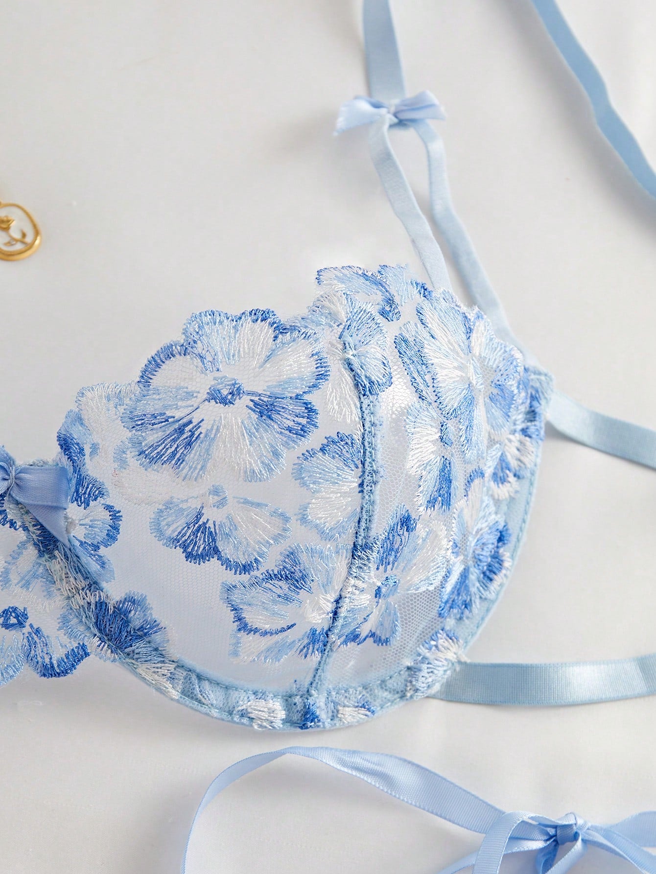 Women’s 2-piece light blue lingerie set with floral embroidery, semi-sheer mesh, and lace-up detail, featuring an ultra-thin underwire bra with adjustable straps and matching low-rise briefs.