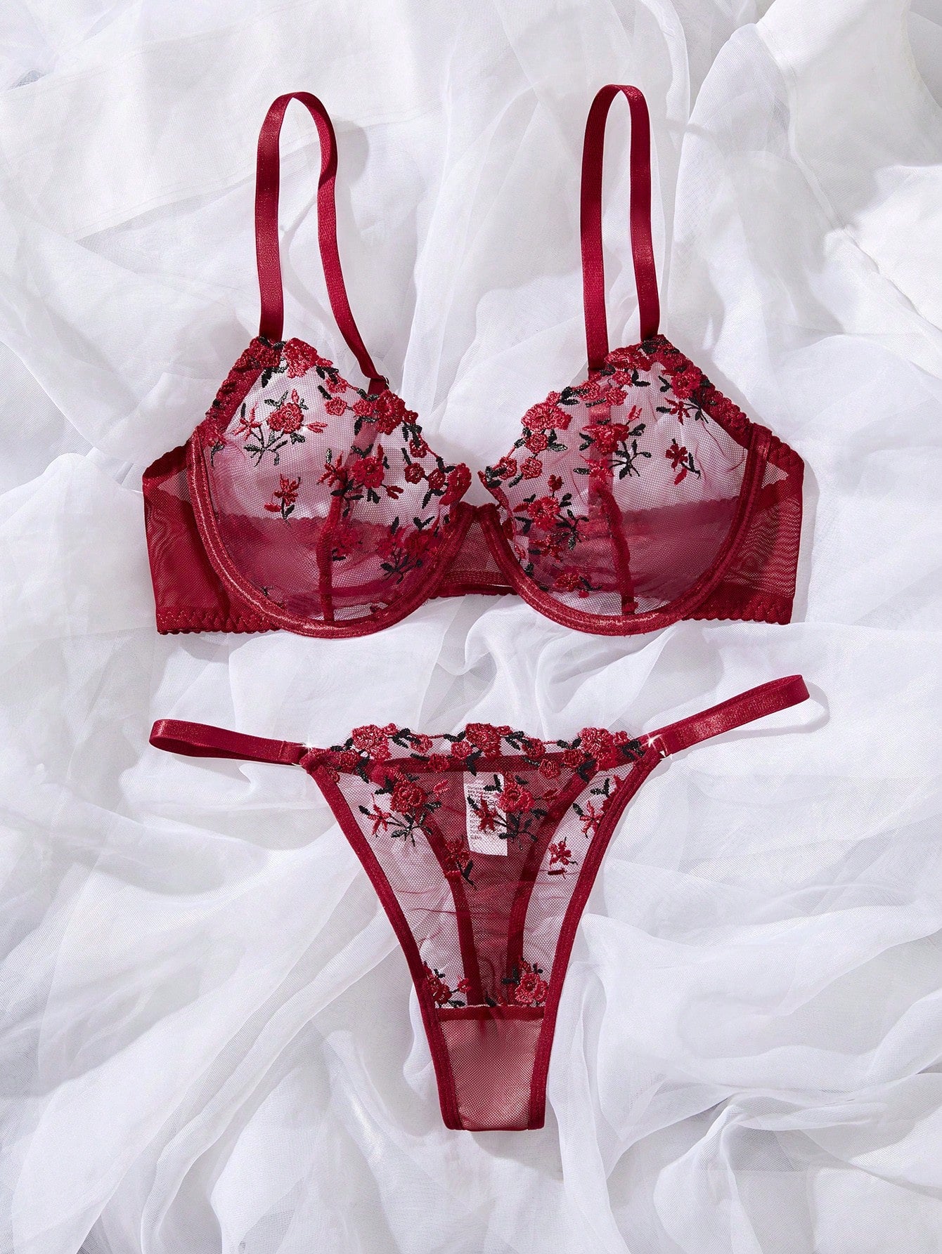 Women's floral embroidered sheer mesh lingerie set featuring a spaghetti strap camisole-style bralette with adjustable straps and a matching low-rise thong.