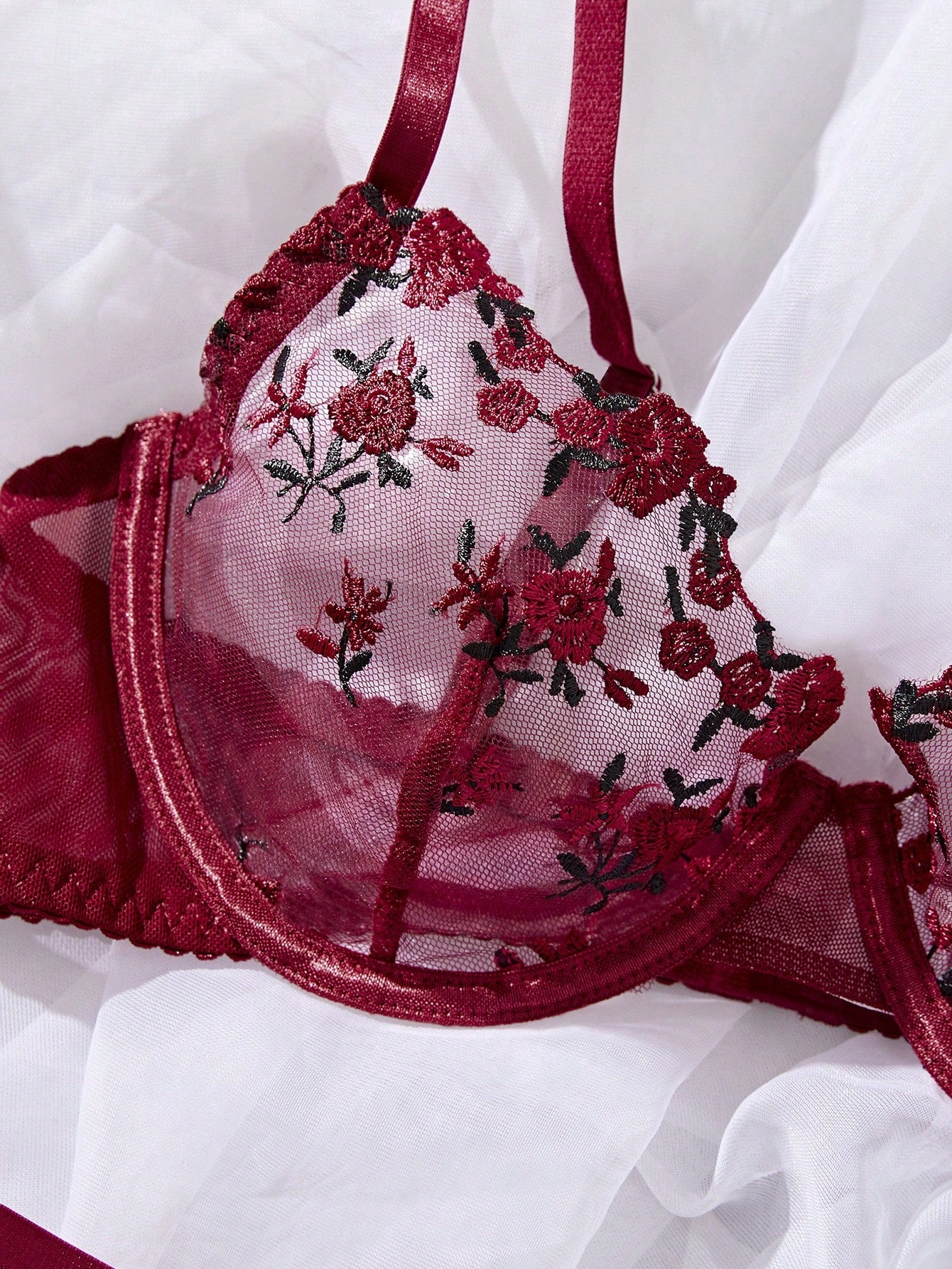 Women's floral embroidered sheer mesh lingerie set featuring a spaghetti strap camisole-style bralette with adjustable straps and a matching low-rise thong.