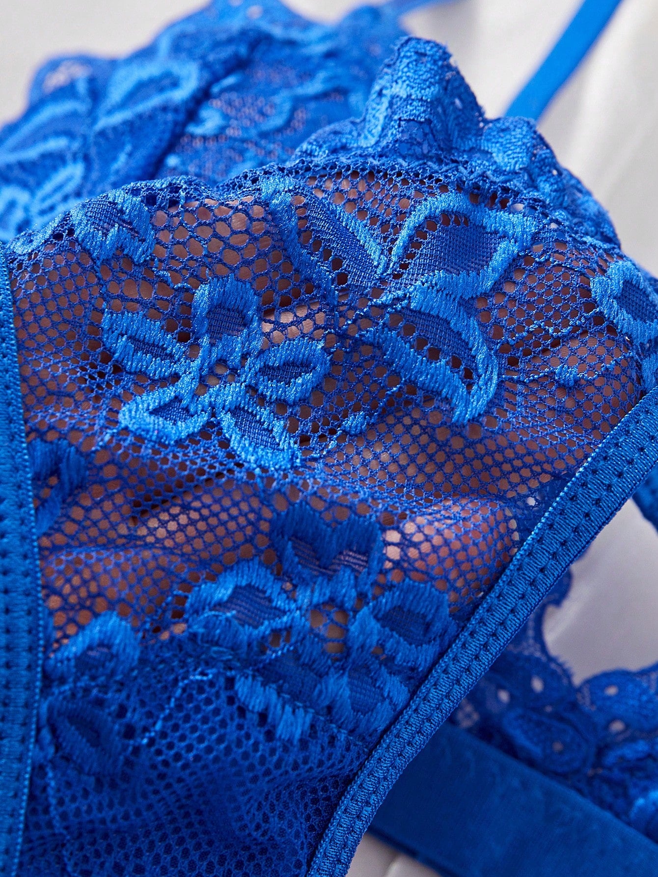 Women's 2-piece lingerie set with a solid color lace patchwork cami bralette featuring spaghetti straps and a crossback design, paired with a matching low-rise thong panty.