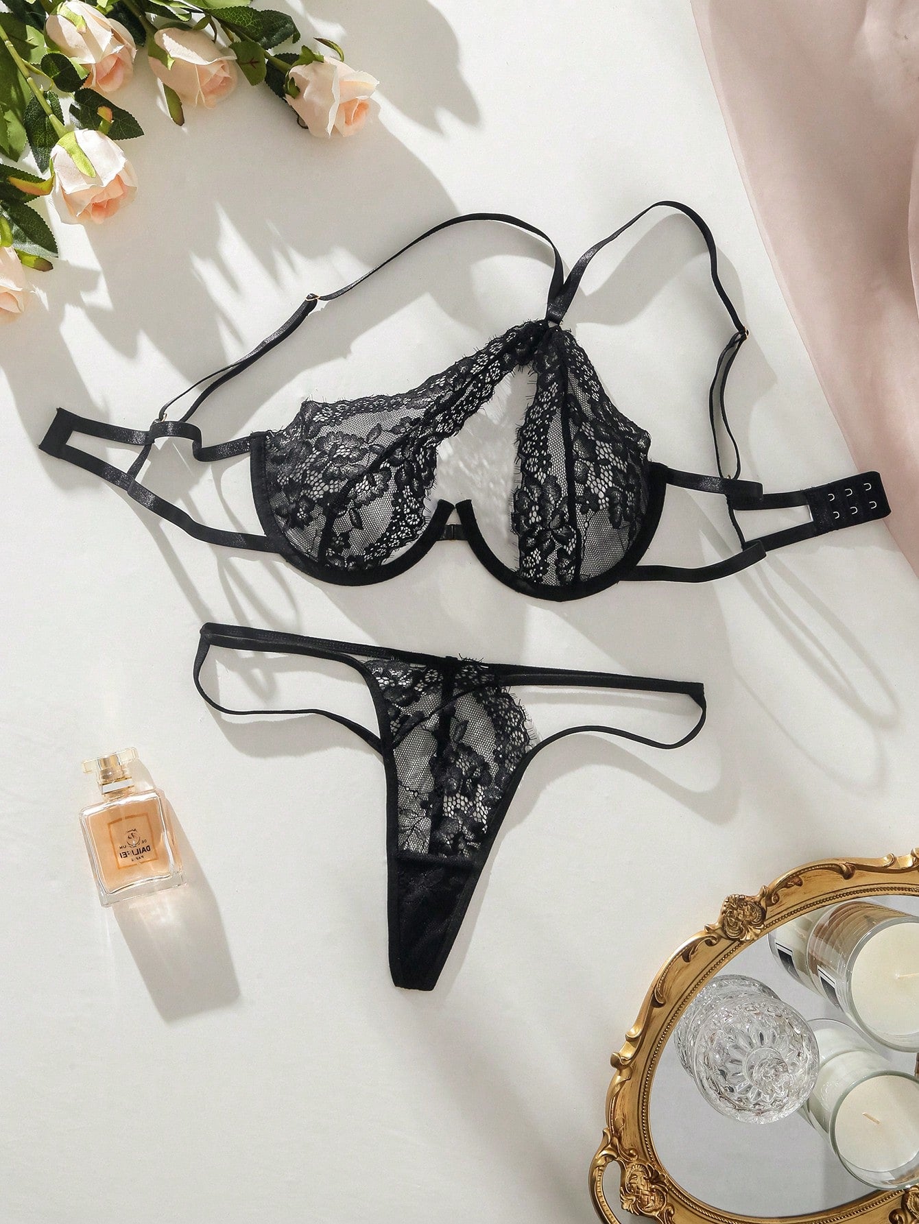 Two-piece women's lingerie set featuring a lace triangle bra with shoulder straps and cut-out details, paired with a low-rise thong panty in a sexy style.
