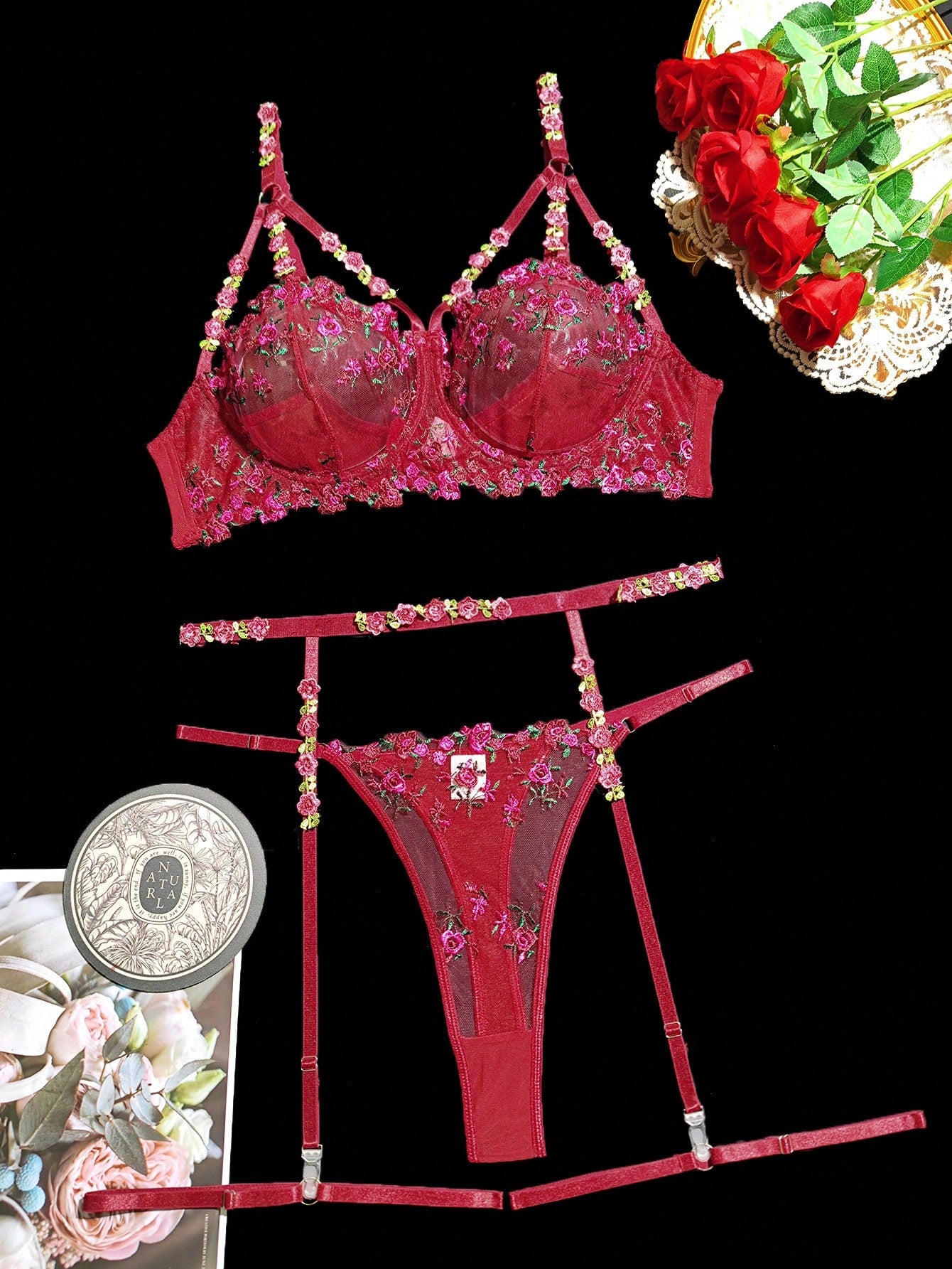 Burgundy plus-size lingerie set with floral embroidery and sheer mesh, featuring underwire cups, adjustable spaghetti straps, a garter detail, and a matching low-rise thong.