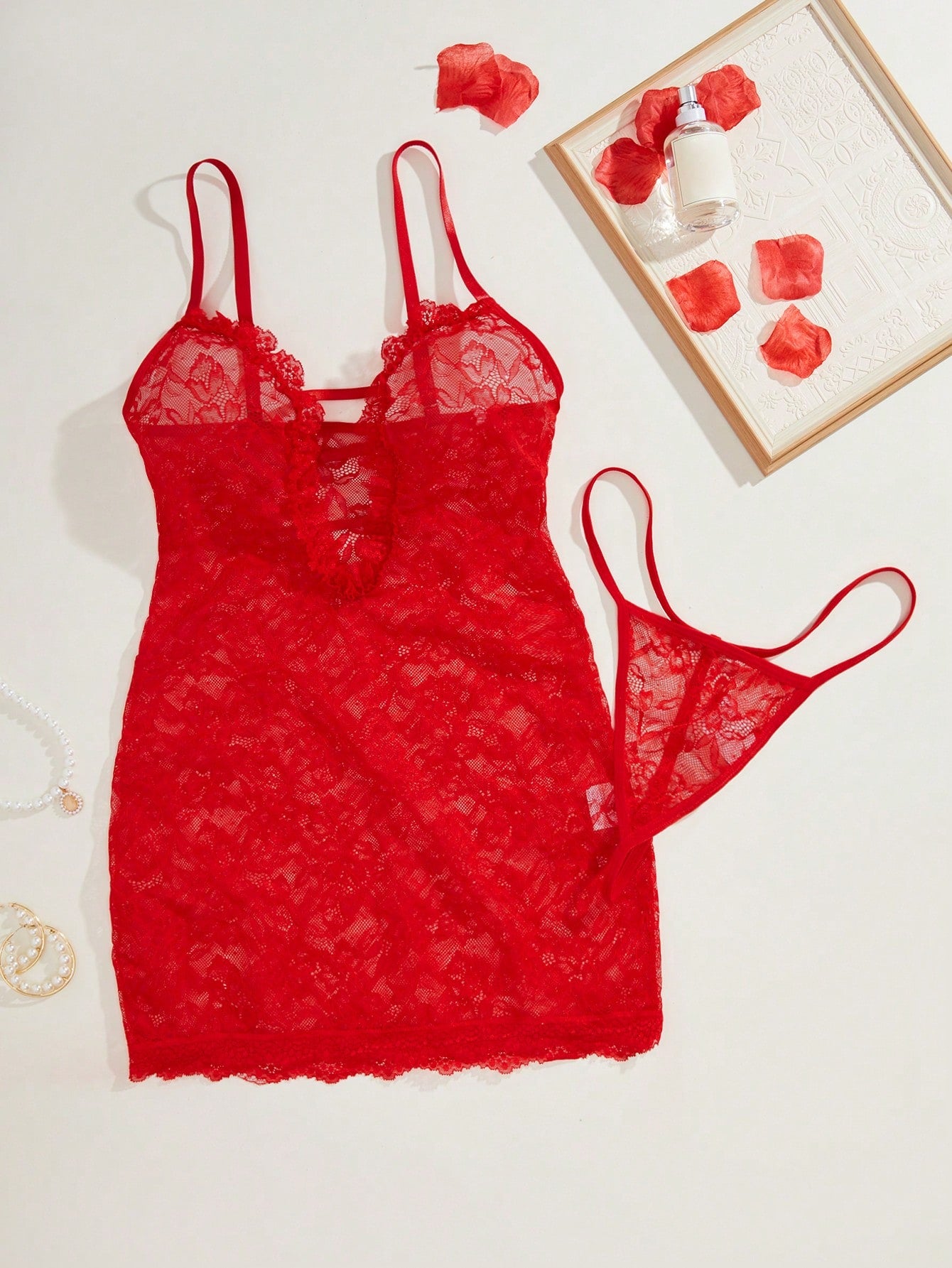 Two-piece sexy lingerie set featuring a short lace slip dress with cutout detail, backless crisscross design, spaghetti straps, and a matching thong.
