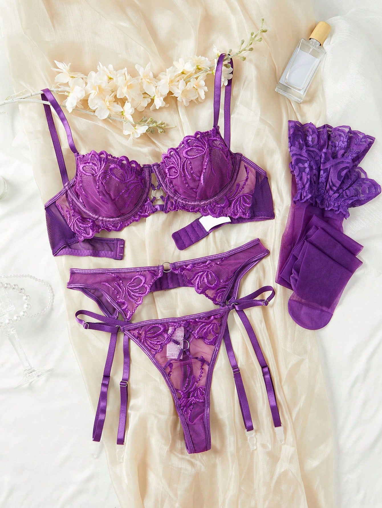 Floral embroidered mesh underwire garter lingerie set with adjustable spaghetti straps, criss-cross detail, and thong panty.