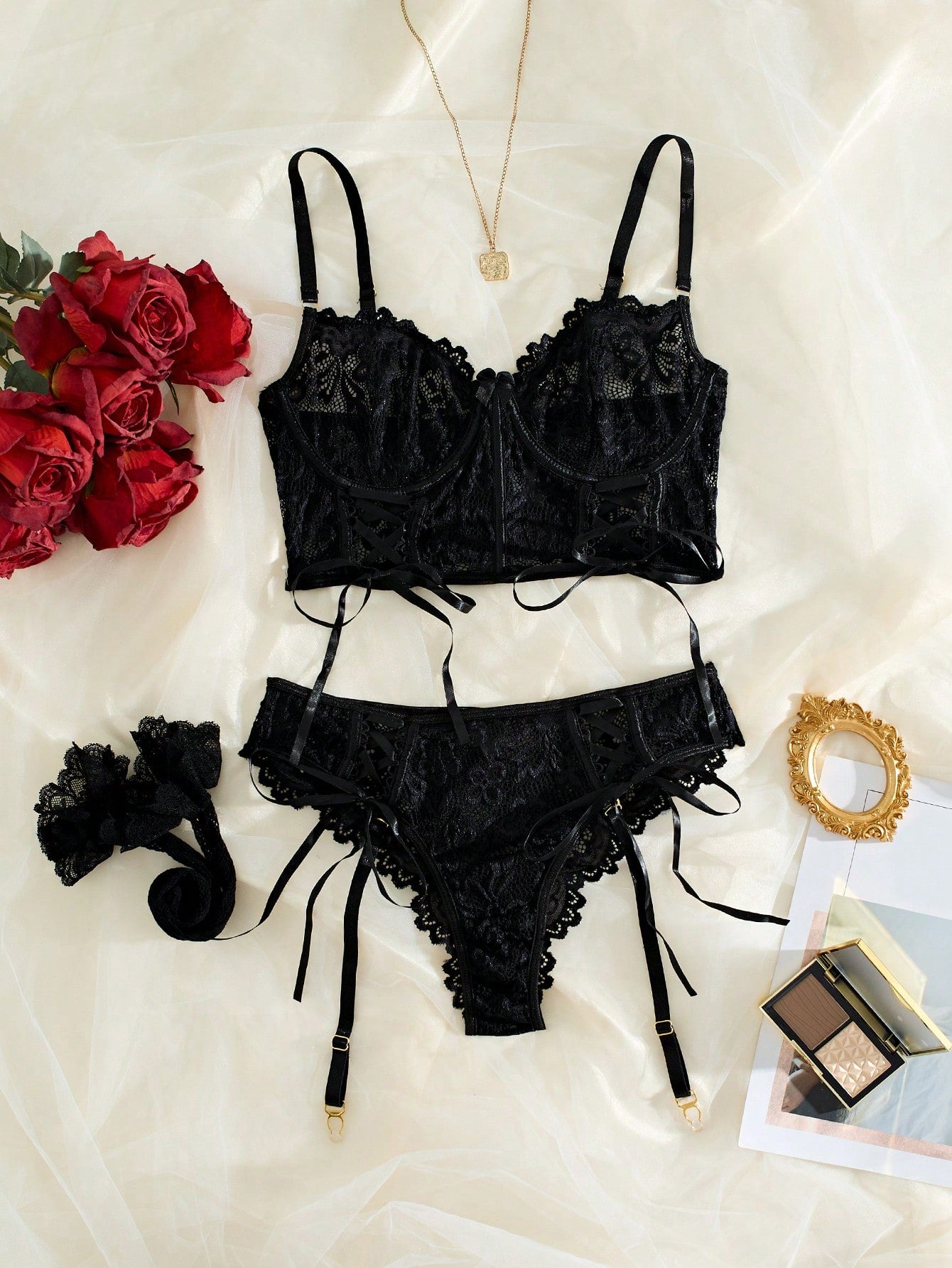 Black floral lace lingerie set with a sheer underwire longline bra, matching mid-rise briefs, garter details, and one pair of stockings.