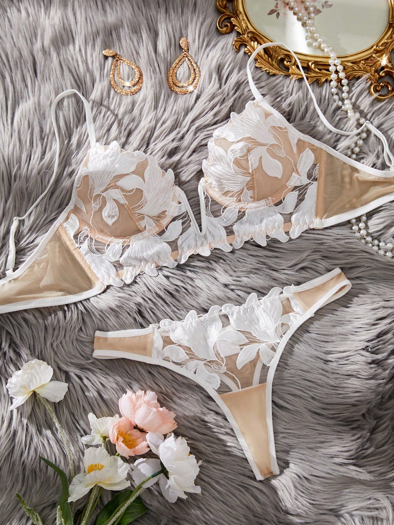 White 2-piece lingerie set with a French classic look, featuring an embroidered sheer underwire bralette with adjustable straps and a matching low-rise thong.