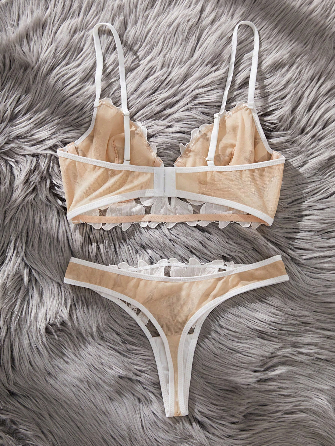 White 2-piece lingerie set with a French classic look, featuring an embroidered sheer underwire bralette with adjustable straps and a matching low-rise thong.