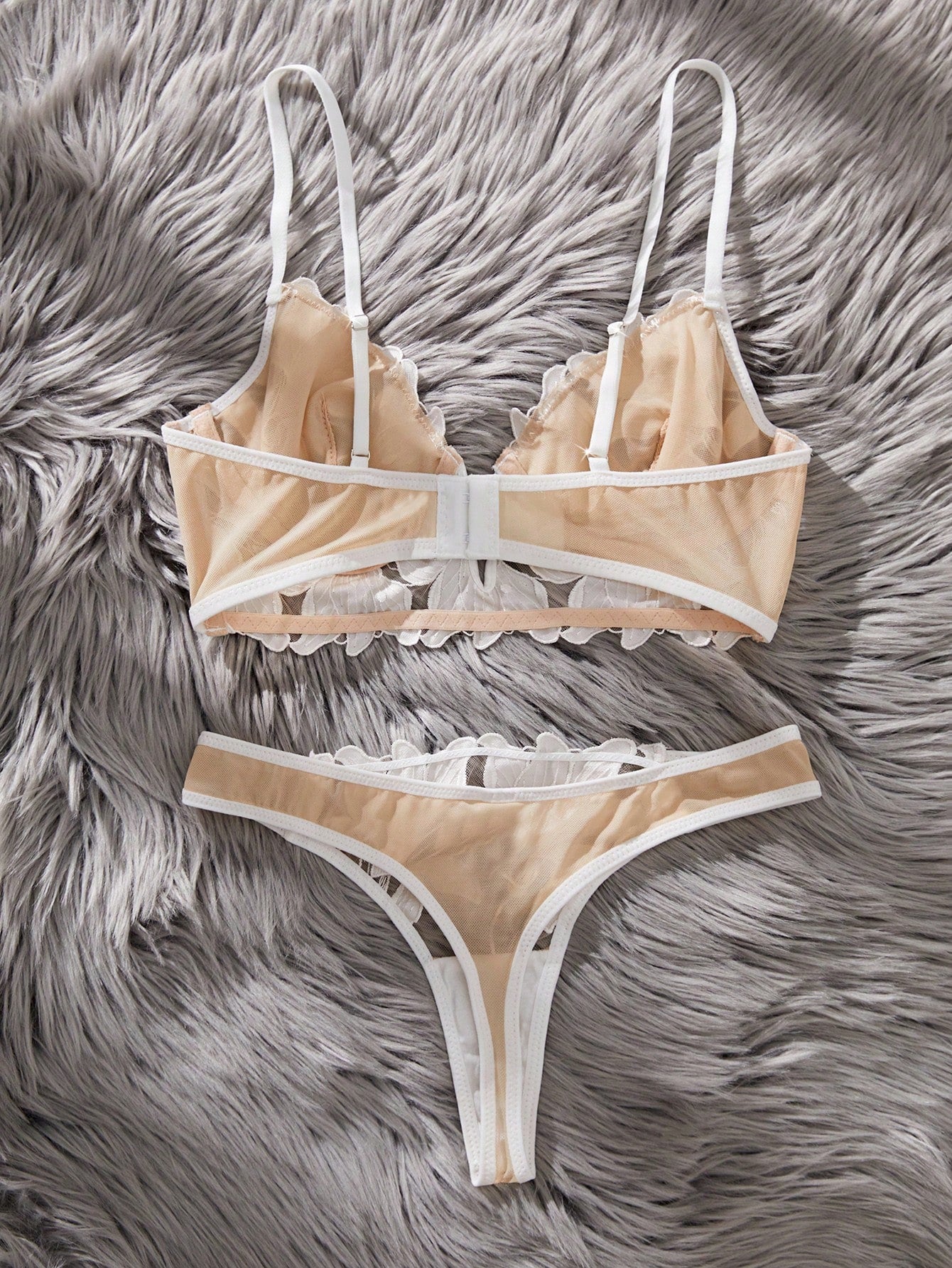White 2-piece lingerie set with a French classic look, featuring an embroidered sheer underwire bralette with adjustable straps and a matching low-rise thong.