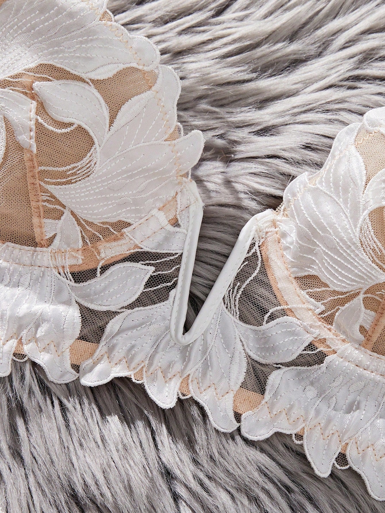 White 2-piece lingerie set with a French classic look, featuring an embroidered sheer underwire bralette with adjustable straps and a matching low-rise thong.