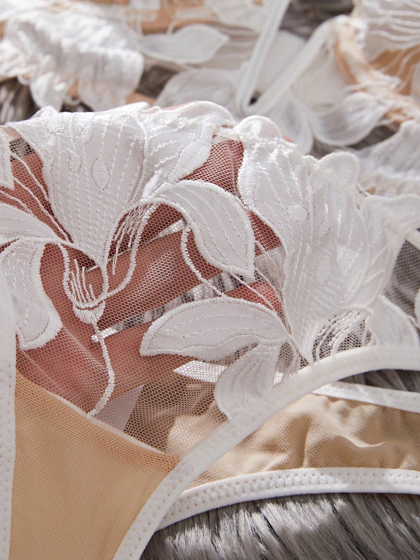 White 2-piece lingerie set with a French classic look, featuring an embroidered sheer underwire bralette with adjustable straps and a matching low-rise thong.