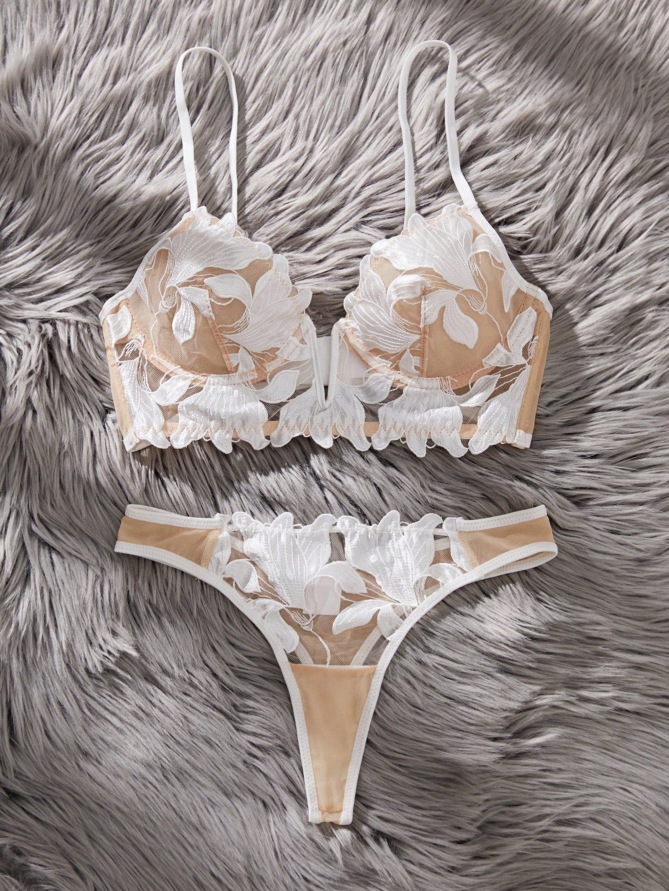 White 2-piece lingerie set with a French classic look, featuring an embroidered sheer underwire bralette with adjustable straps and a matching low-rise thong.