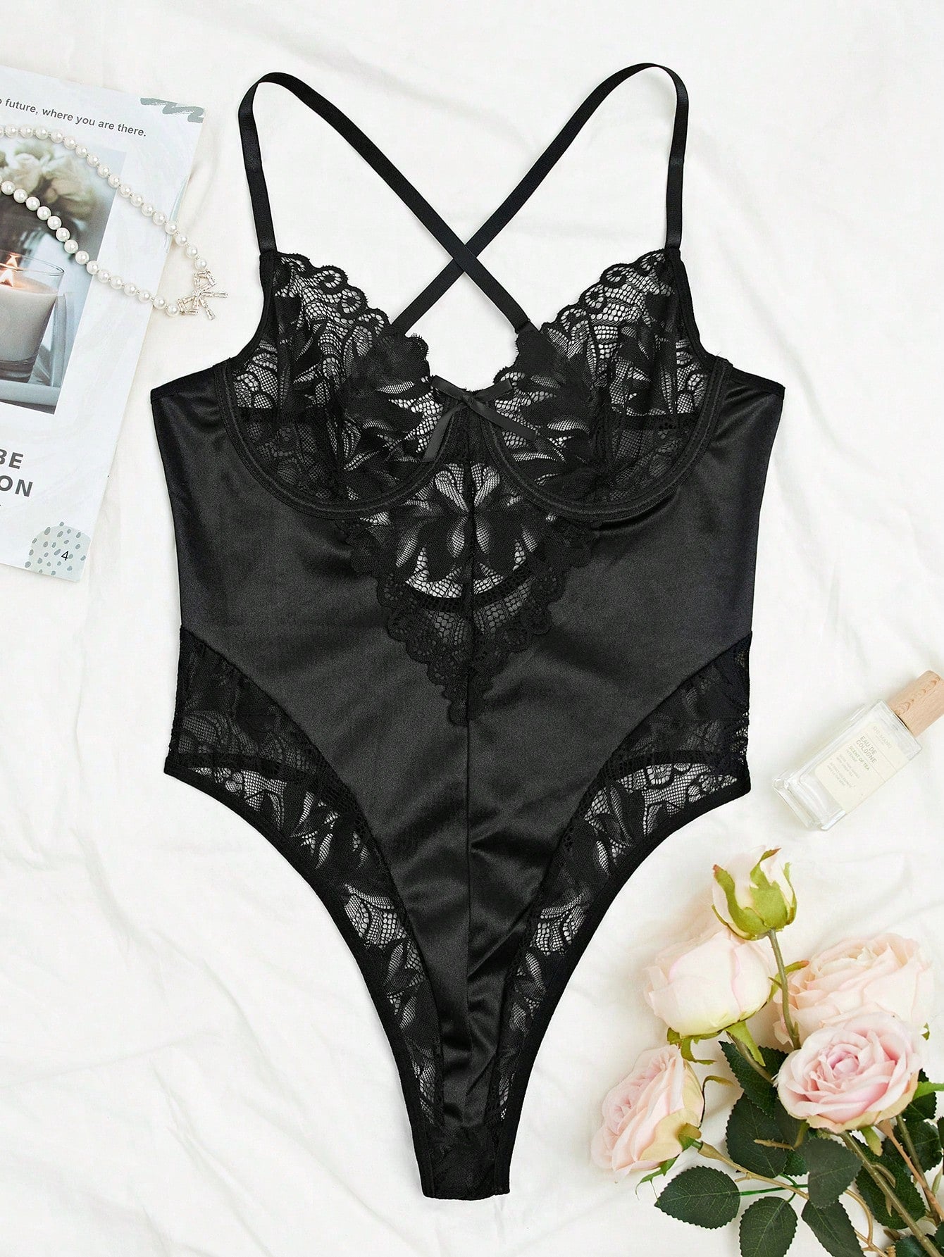 Black cross-strap lace lingerie bodysuit teddy with adjustable spaghetti straps, underwire half-cup design, thong back, and low-rise fit.