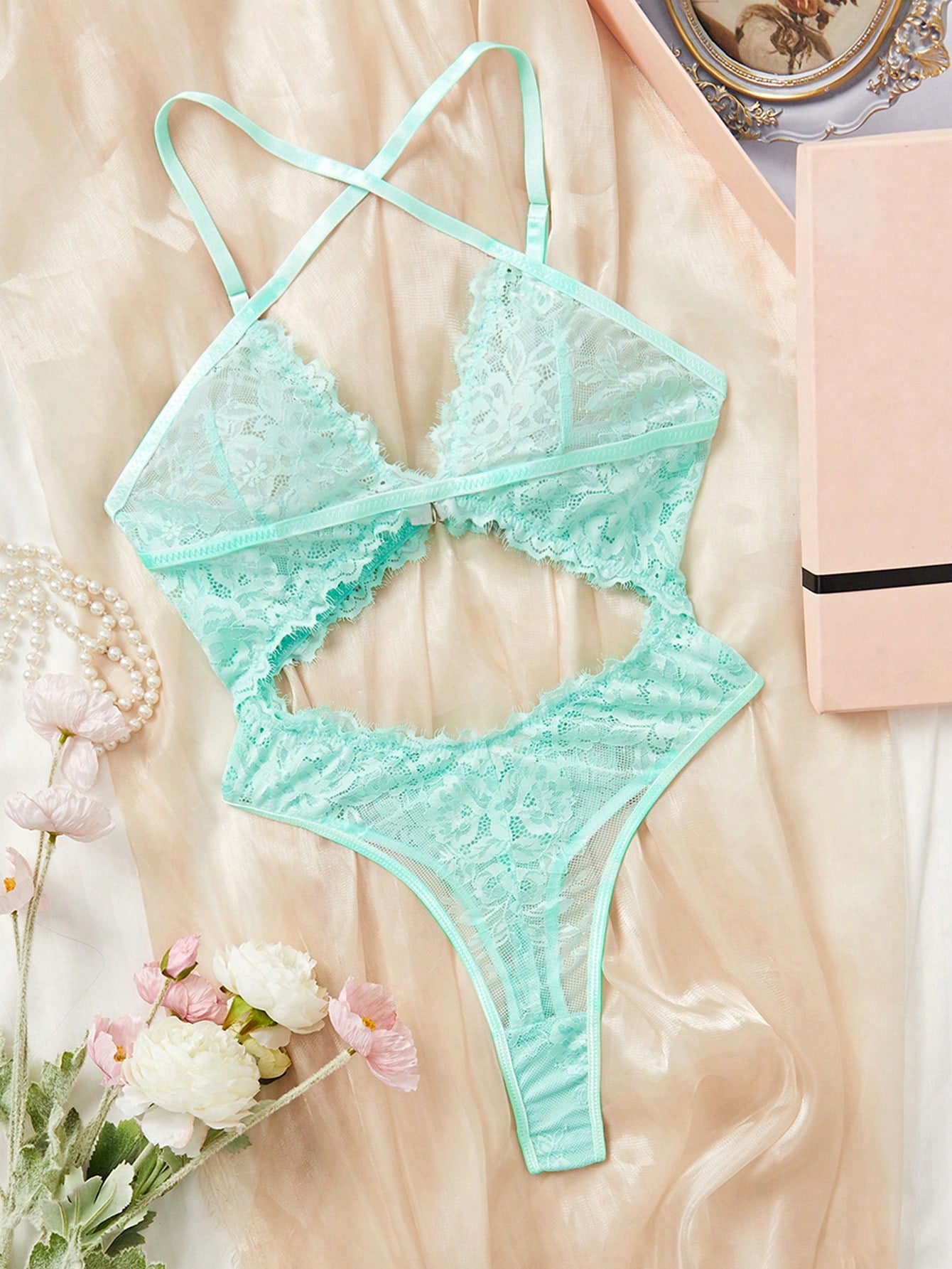 Dark green women’s lace teddy bodysuit set featuring spaghetti straps, backless criss-cross detailing, cut-out accents, and a thong-style high-rise bottom; semi-sheer lace with adjustable straps and wireless bralette support.