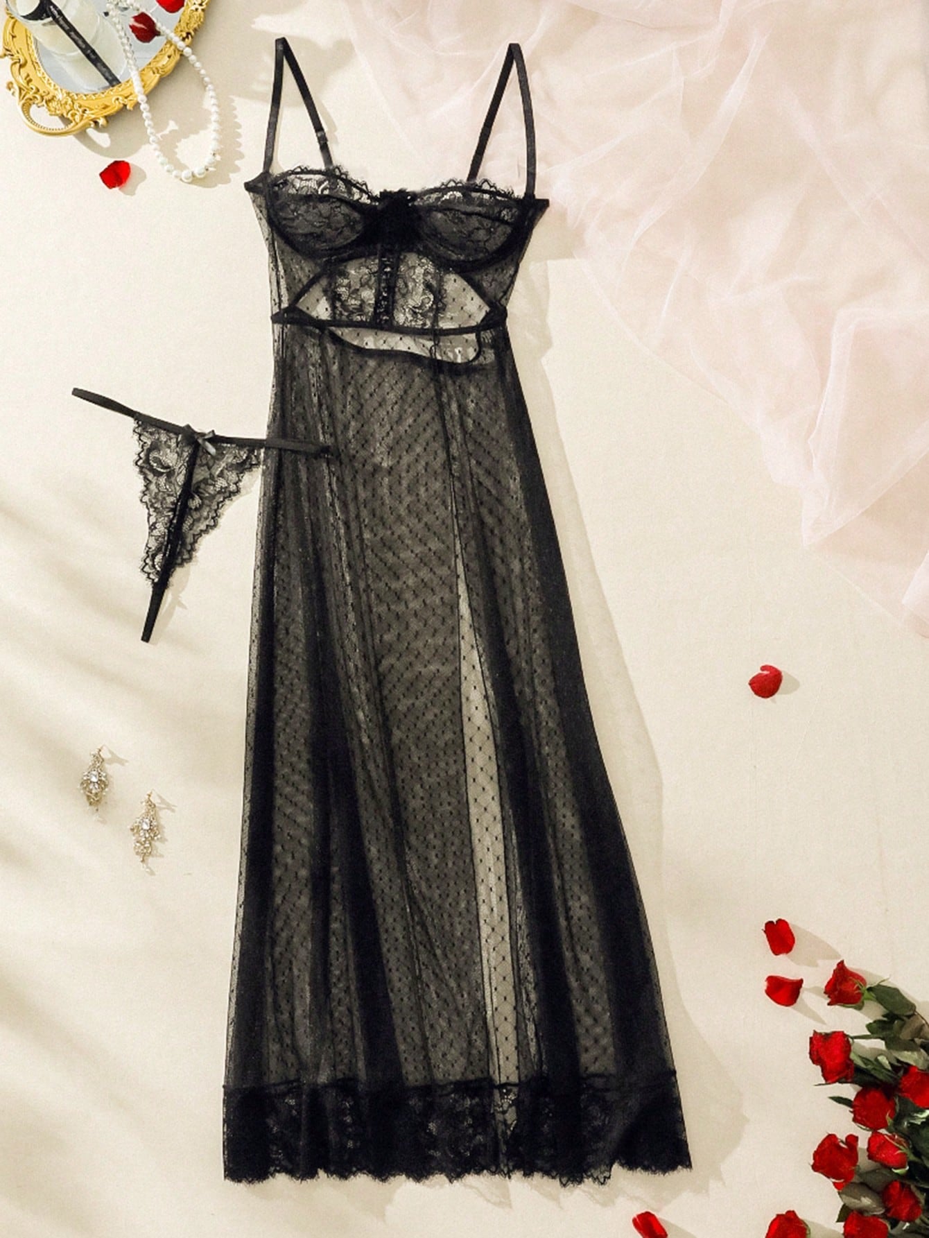 Black sheer lace lingerie dress with a high slit, spaghetti straps, and bow detail, shown with a matching low-rise thong in a 2-piece set.