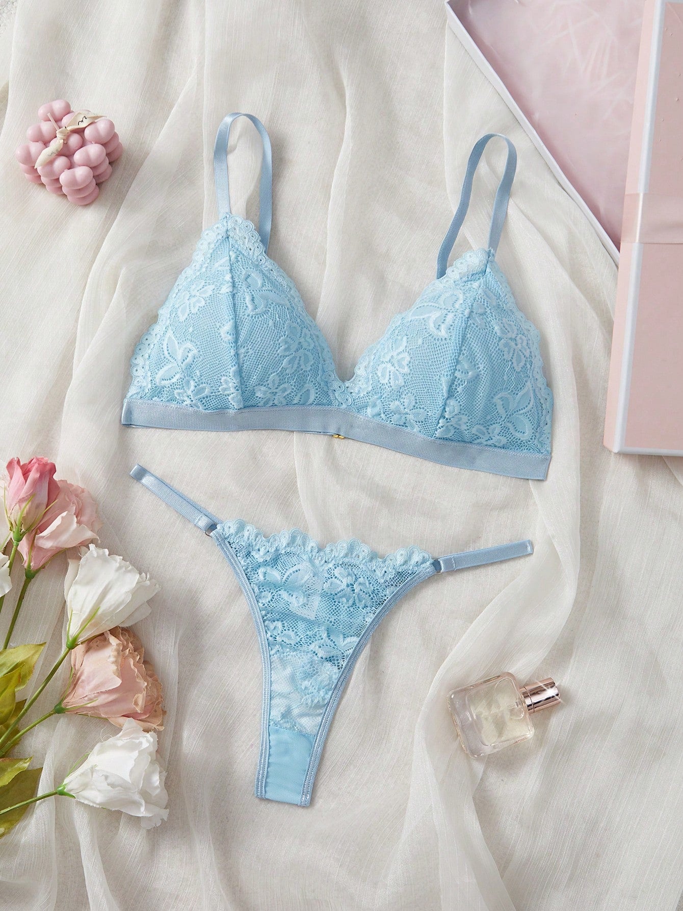 Women's 2-piece lingerie set with a solid color lace patchwork cami bralette featuring spaghetti straps and a crossback design, paired with a matching low-rise thong panty.