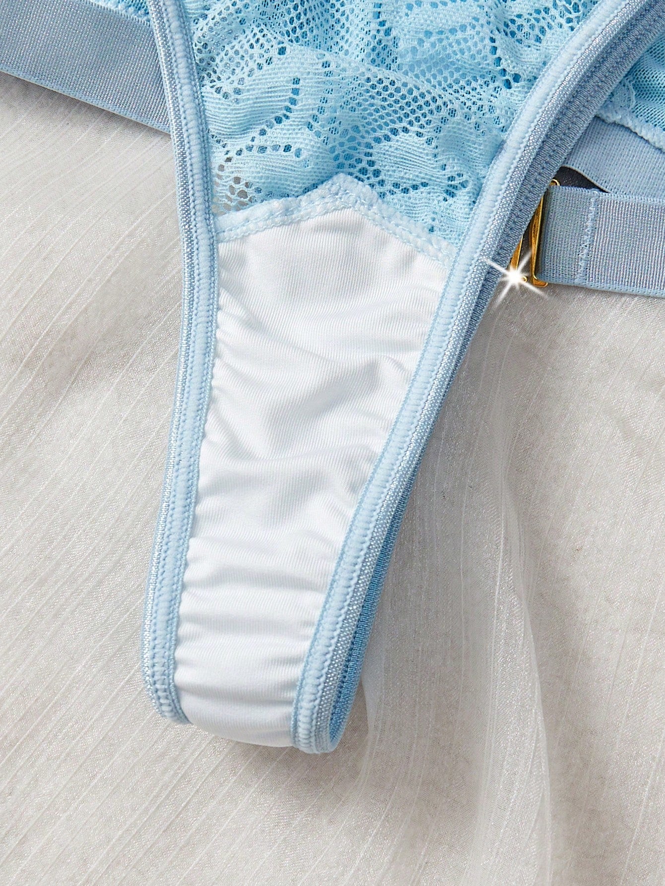 Women’s 2-piece lace patchwork solid-color lingerie set with a spaghetti-strap crossback bralette and low-rise thong panty, styled for romantic or festival looks.