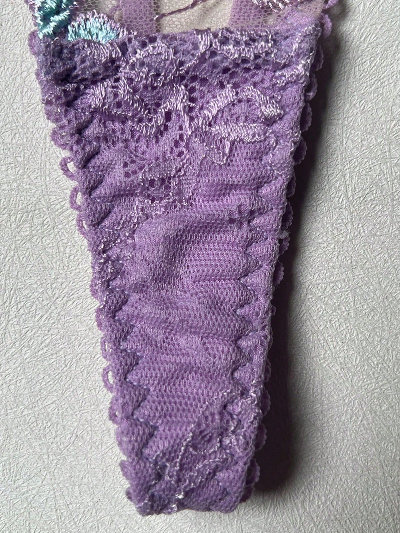 Women's romantic purple lingerie set with embroidered sheer bralette and matching thongs, featuring underwire support, triangle cups, and adjustable spaghetti straps in a 5-piece set.