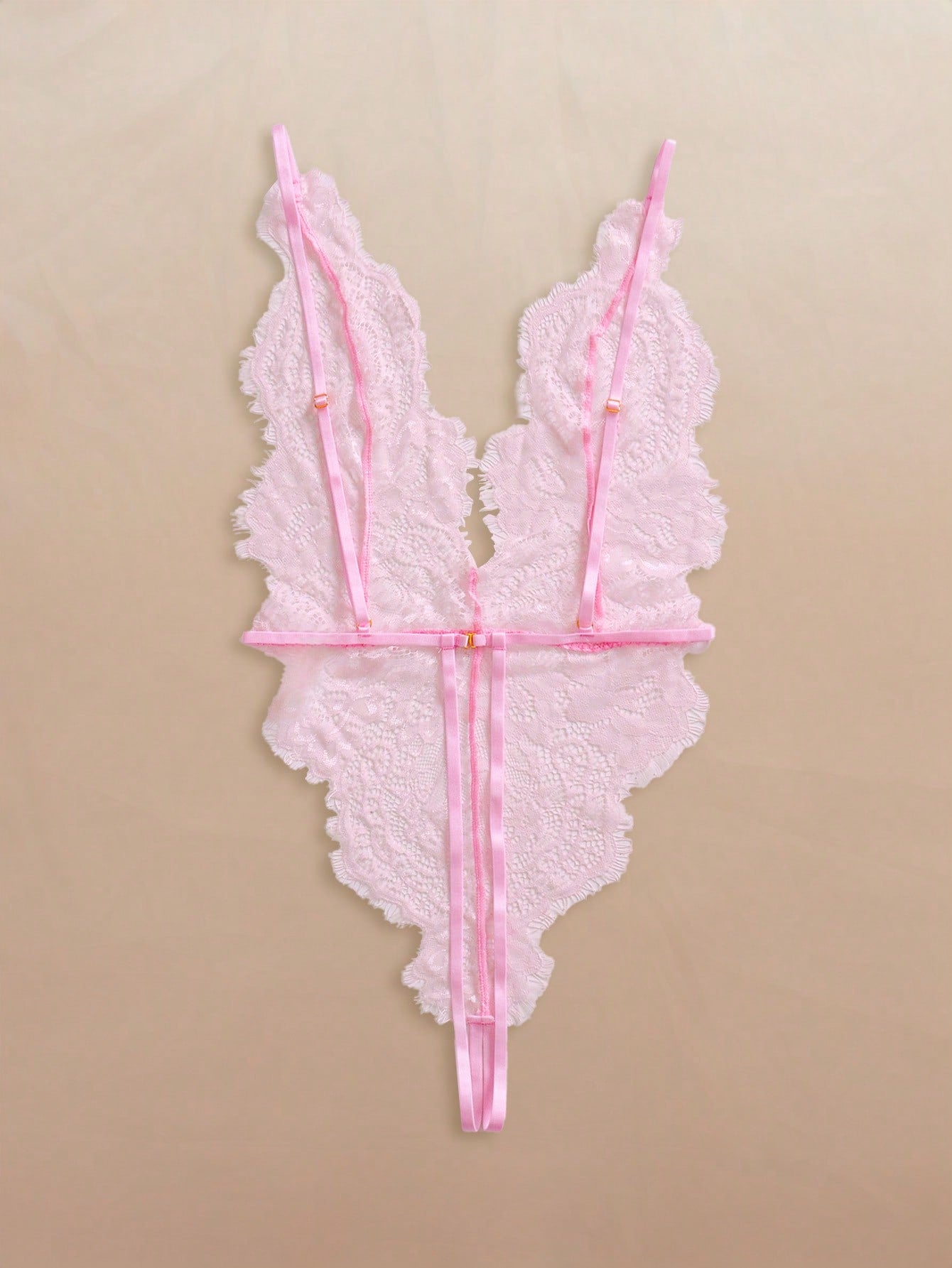 Two-piece women’s lingerie set featuring a floral lace plunging teddy bodysuit with adjustable spaghetti straps and a matching short belted robe with long sleeves and semi-sheer lace detail.