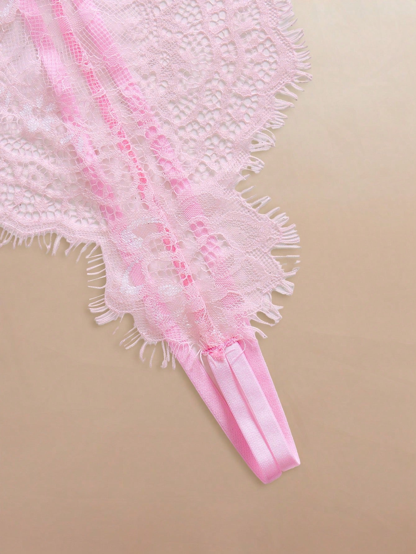 Two-piece women’s lingerie set featuring a floral lace plunging teddy bodysuit with adjustable spaghetti straps and a matching short belted robe with long sleeves and semi-sheer lace detail.