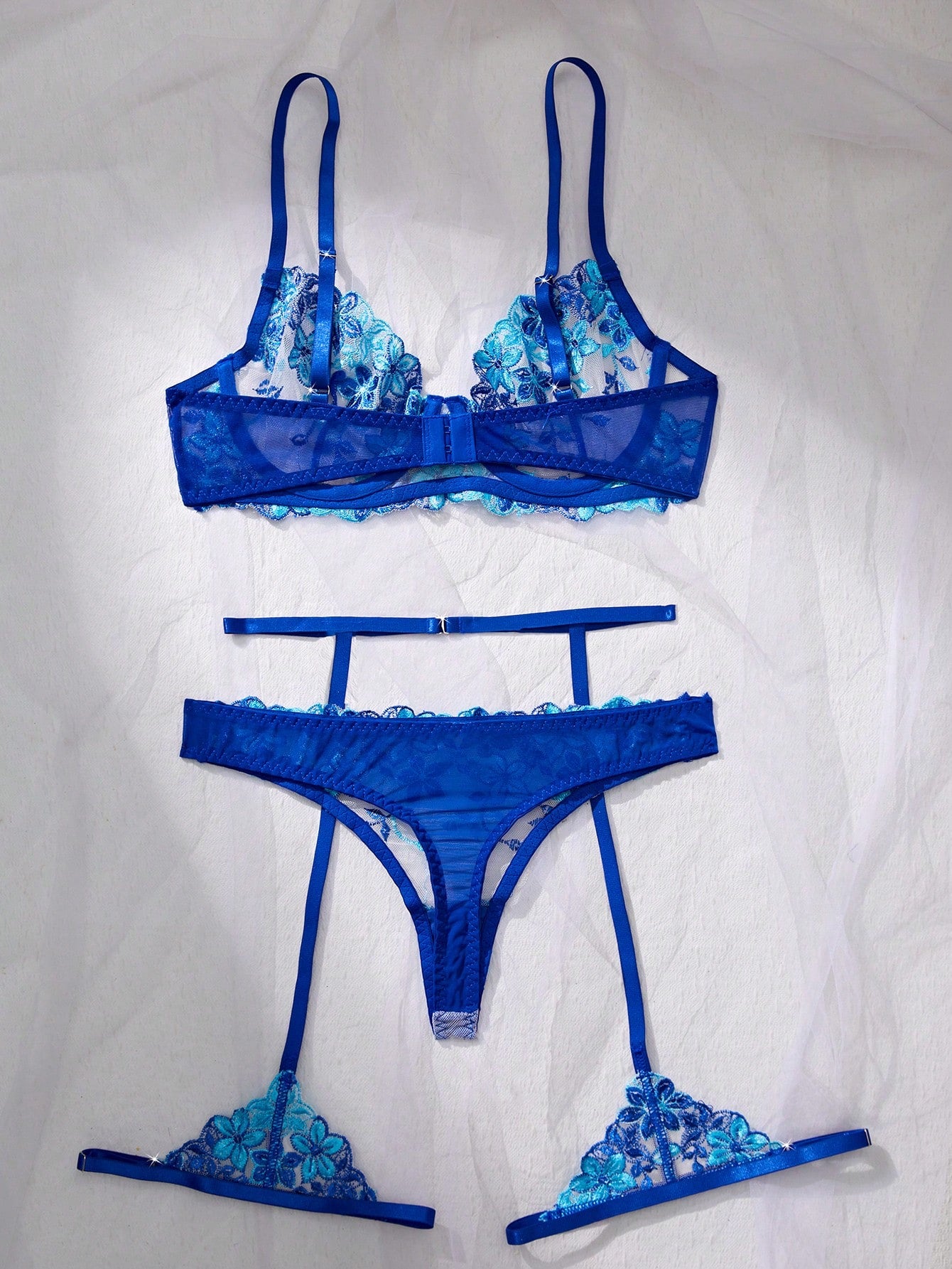 Three-piece women’s sexy lingerie set featuring floral embroidery and sheer details, with a spaghetti strap underwire bralette and matching low-rise briefs.