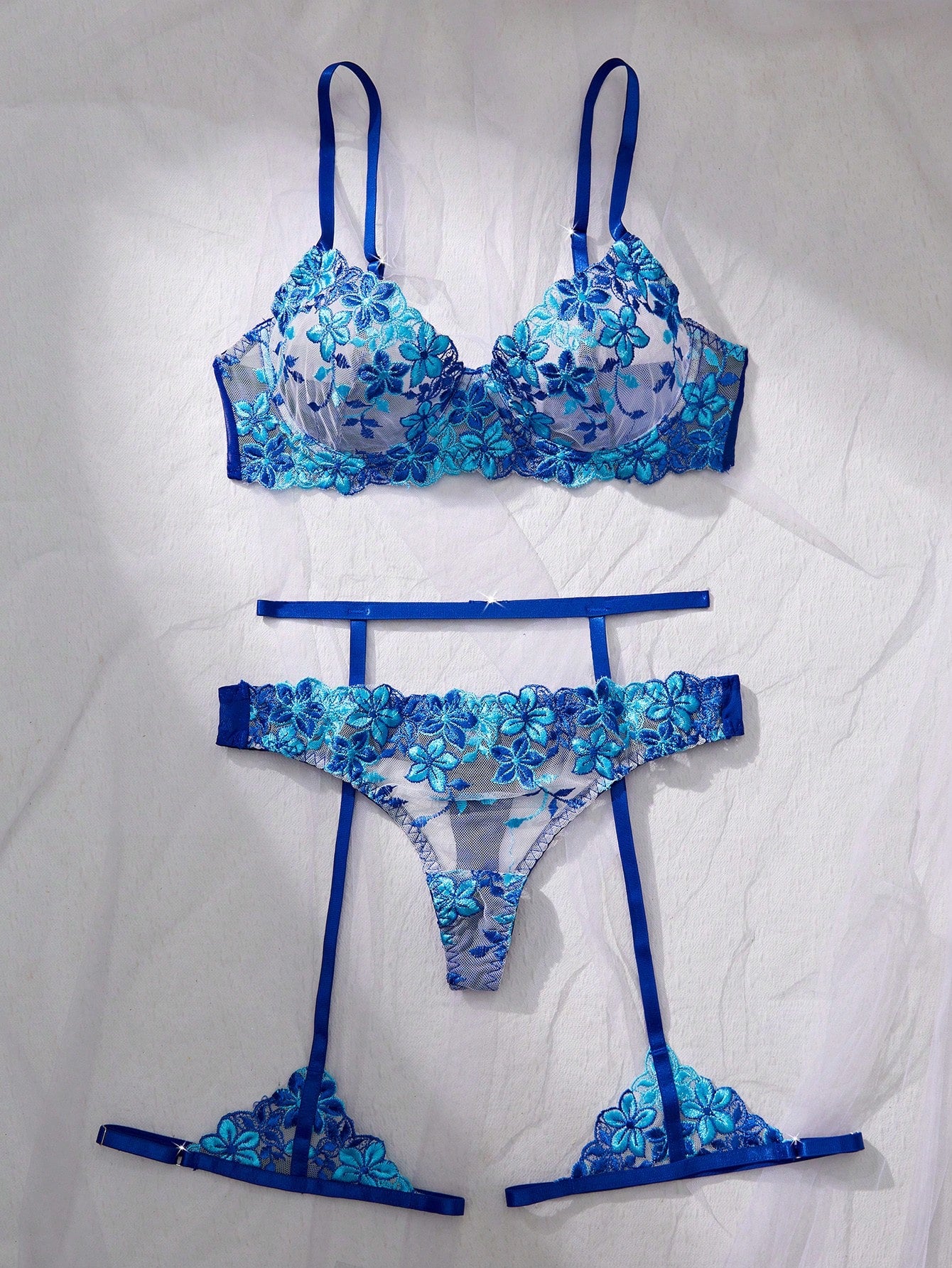 Three-piece women’s sexy lingerie set featuring floral embroidery and sheer details, with a spaghetti strap underwire bralette and matching low-rise briefs.