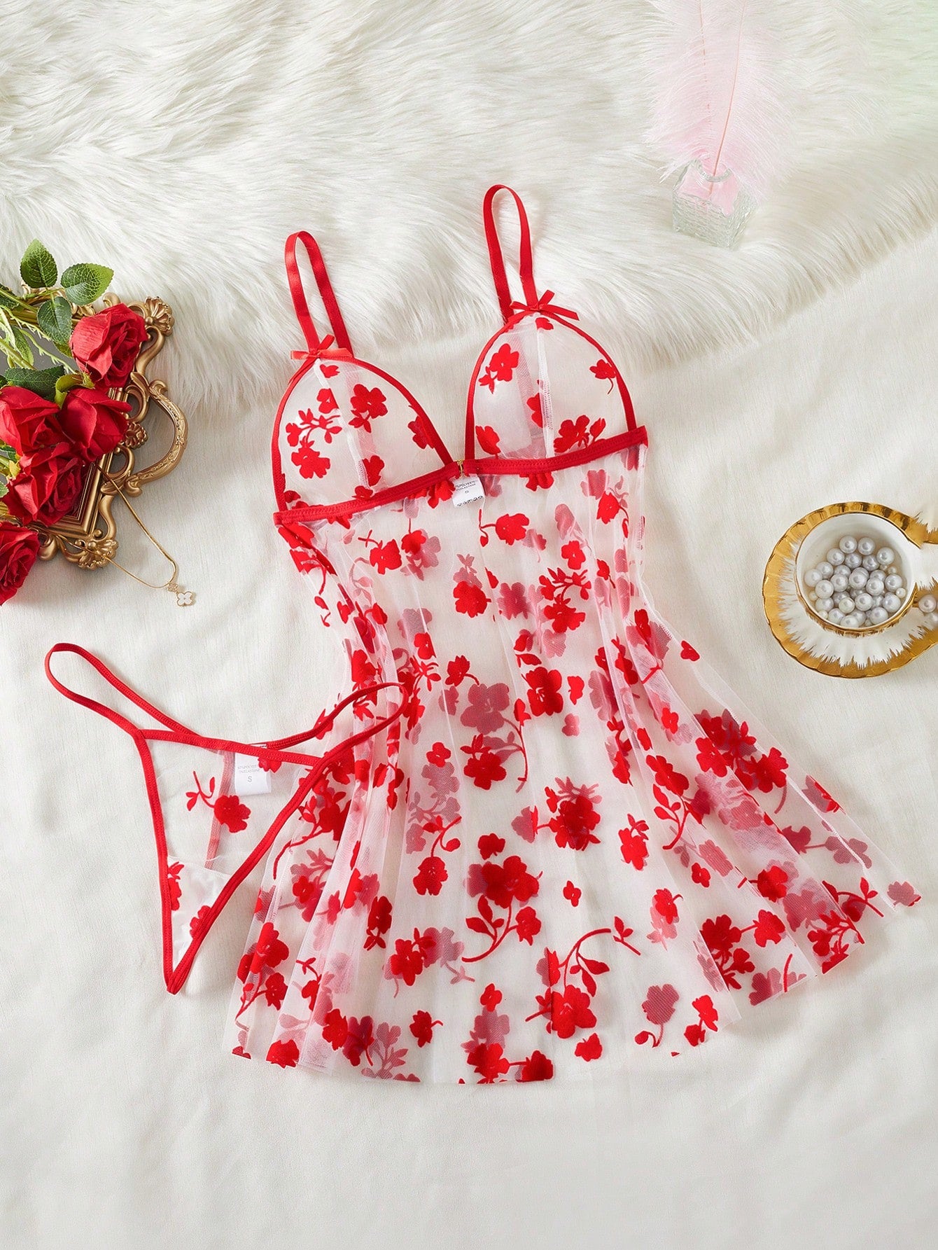 Blue 2-piece women’s lingerie set with floral print mesh and embroidery details, featuring a front-closure spaghetti strap babydoll with adjustable straps and a matching low-rise thong; semi-sheer, sleeveless, and wireless design.
