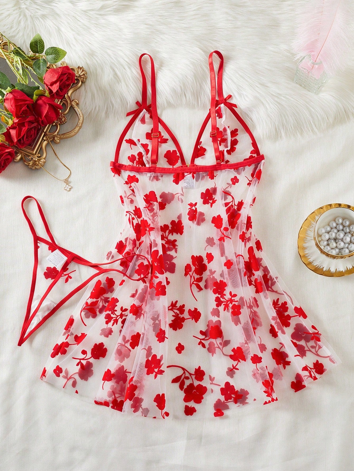 Two-piece women’s floral mesh sleepwear set featuring a front-clasp sheer embroidered bralette with adjustable spaghetti straps and a matching low-rise thong.