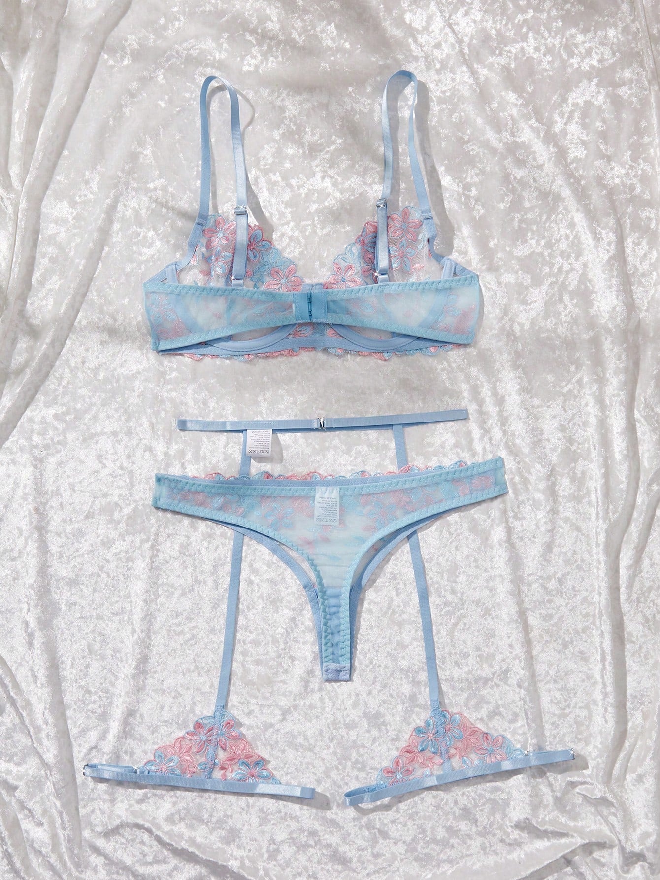 Three-piece women’s sexy lingerie set featuring floral embroidery and sheer details, with a spaghetti strap underwire bralette and matching low-rise briefs.