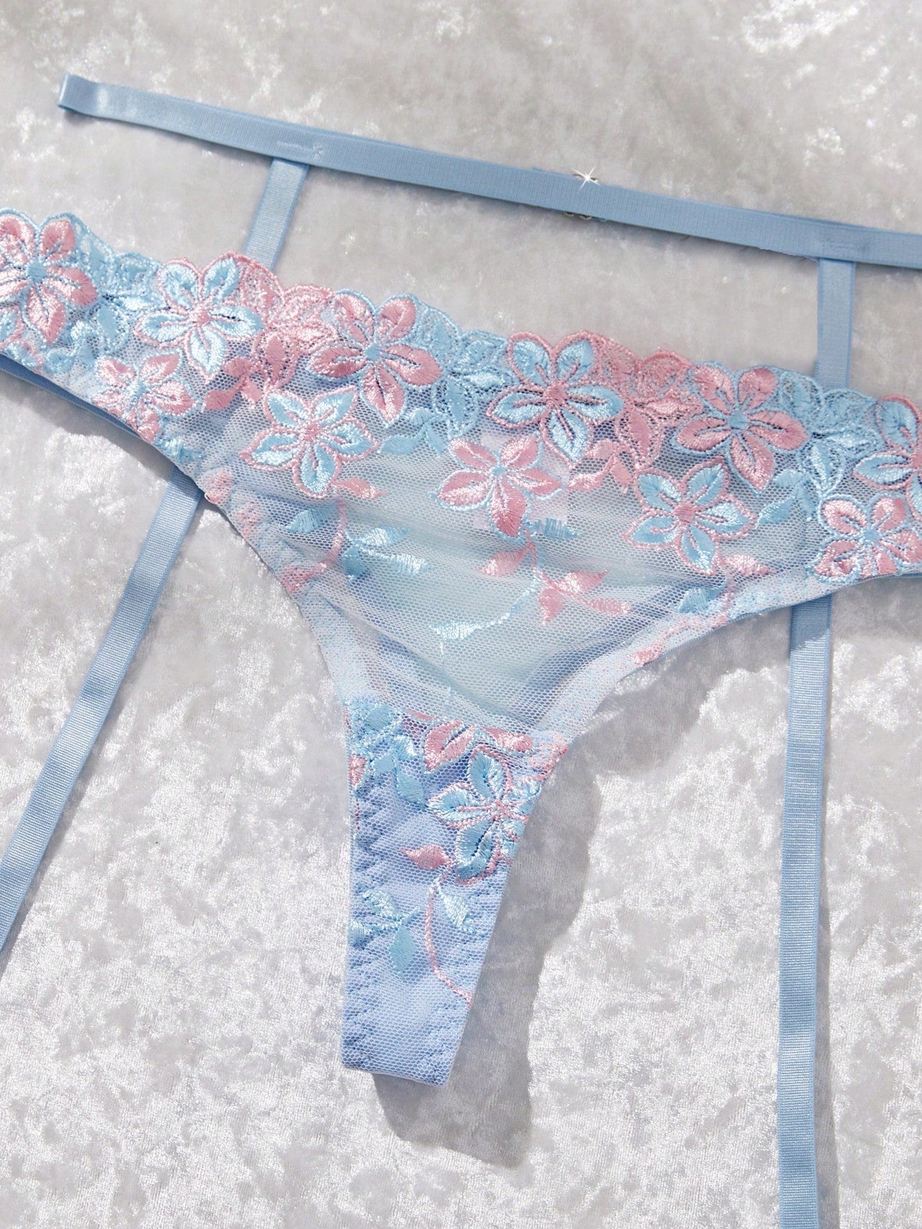 Three-piece women’s sexy lingerie set featuring floral embroidery and sheer details, with a spaghetti strap underwire bralette and matching low-rise briefs.