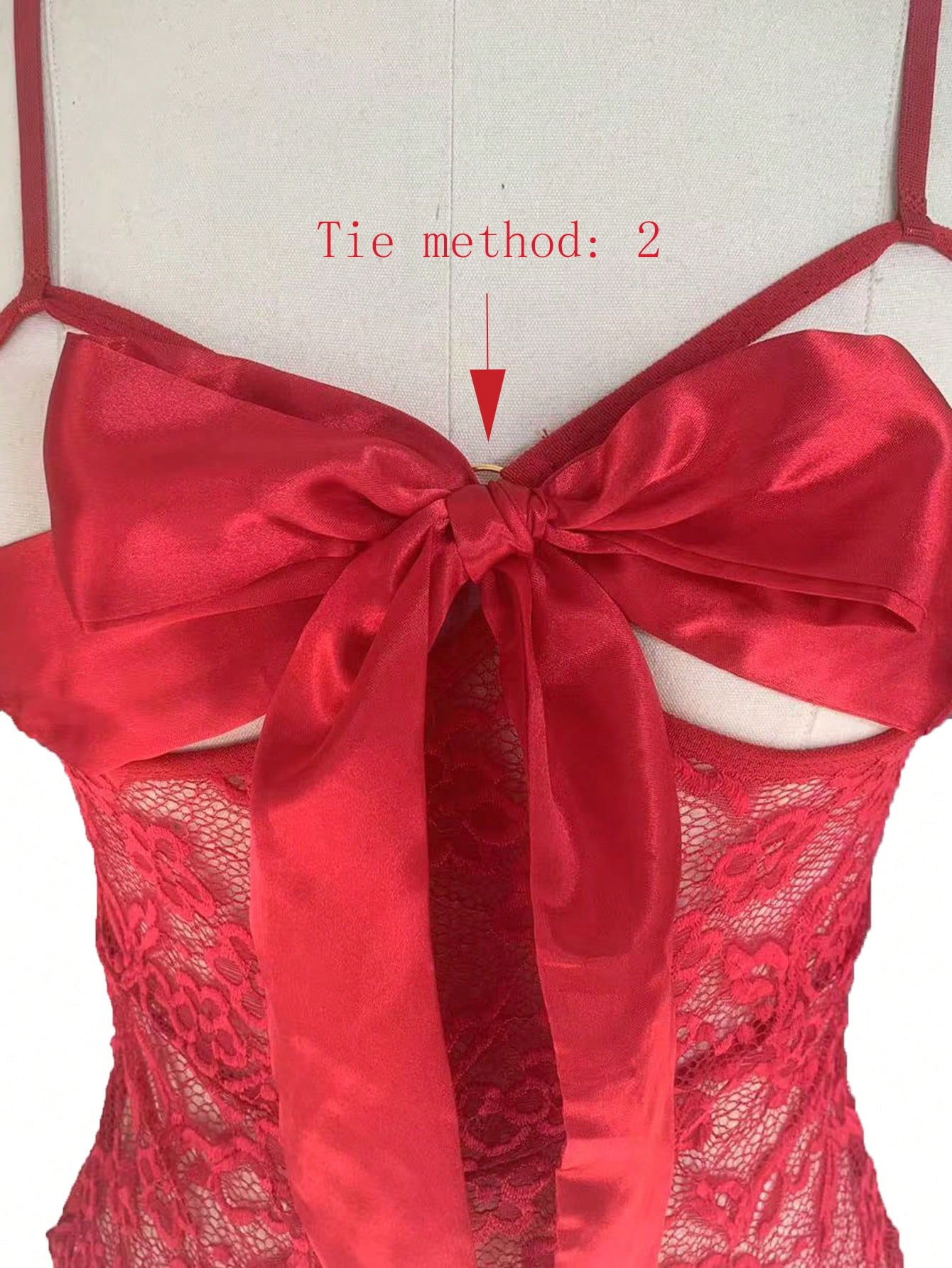 Burgundy lace crotchless bodysuit lingerie set with a deep V neckline, sheer cut-out design, and tie-front bow satin ribbon detail; sleeveless, wireless, and semi-sheer.