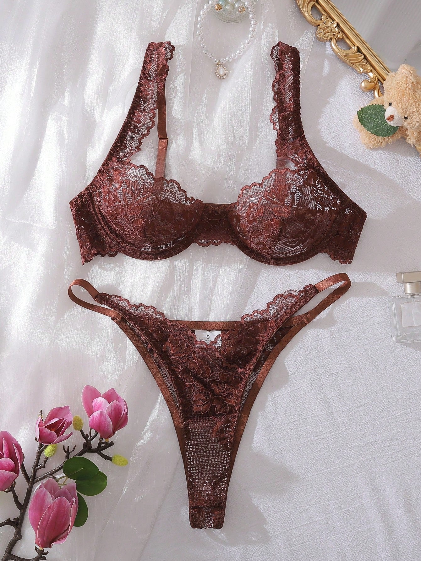 White lace underwire bra and matching thong lingerie set with adjustable spaghetti straps, triangle cups, and semi-sheer contrast lace details.