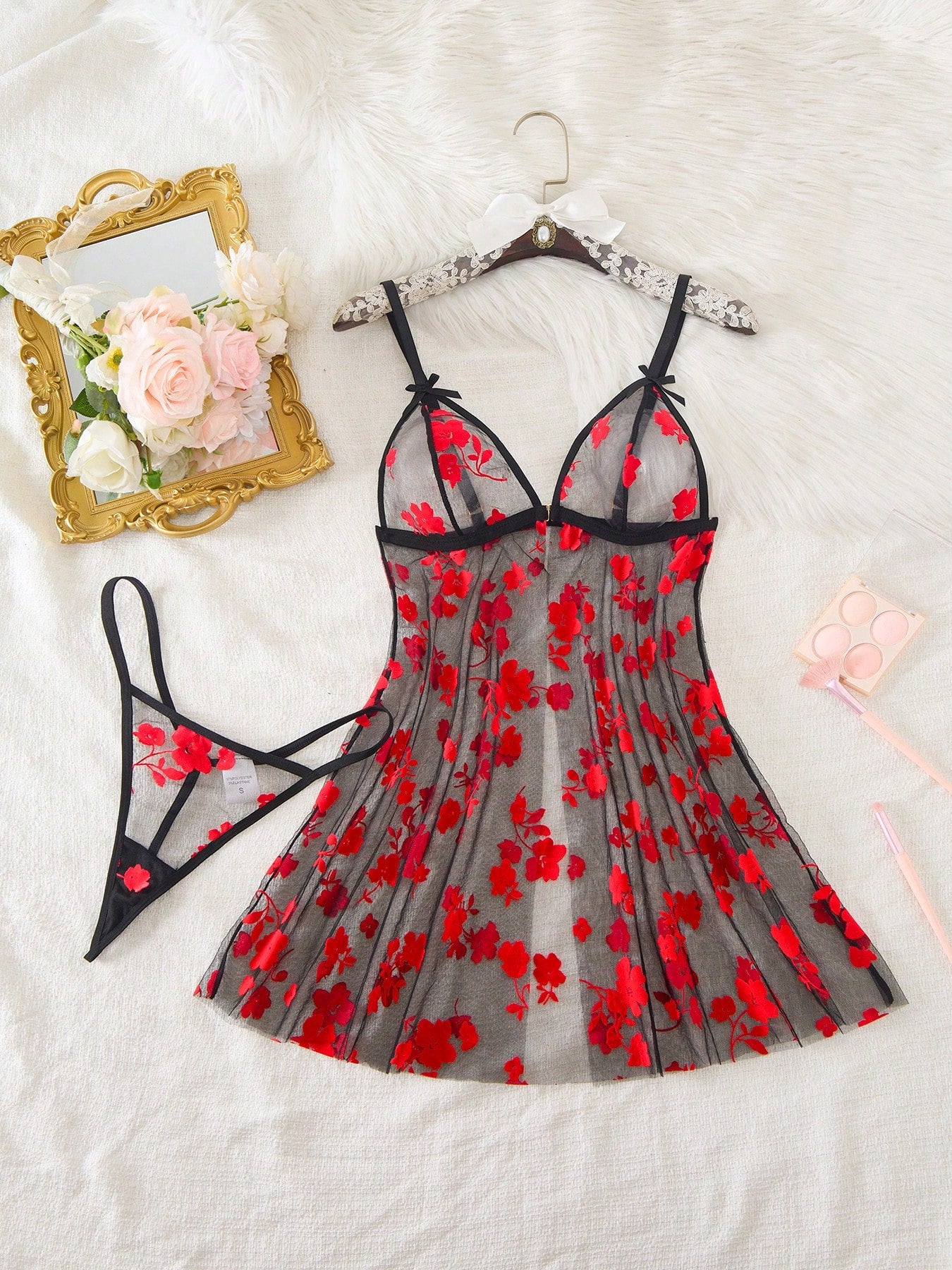 Blue 2-piece women’s lingerie set with floral print mesh and embroidery details, featuring a front-closure spaghetti strap babydoll with adjustable straps and a matching low-rise thong; semi-sheer, sleeveless, and wireless design.