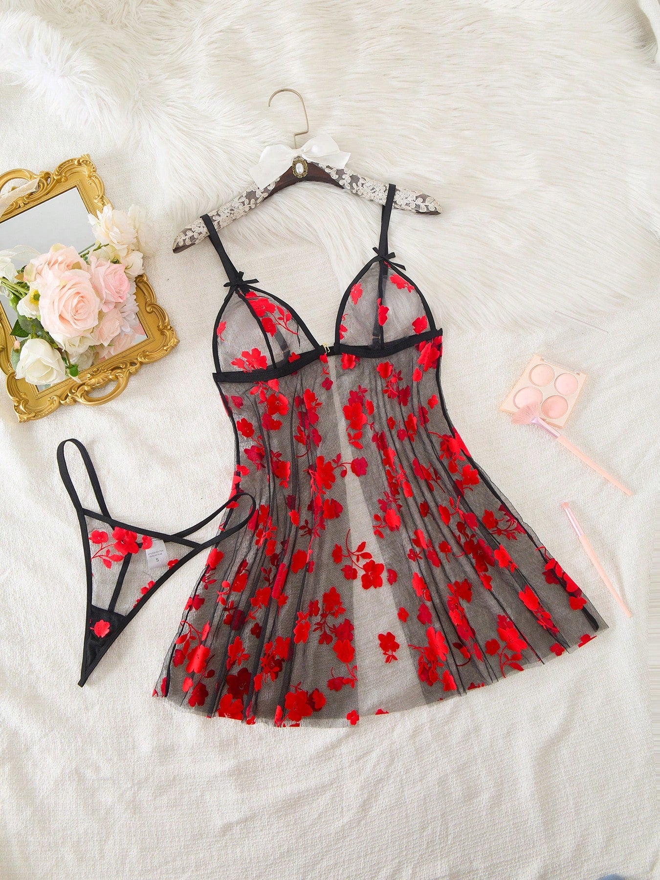 Blue 2-piece women’s lingerie set with floral print mesh and embroidery details, featuring a front-closure spaghetti strap babydoll with adjustable straps and a matching low-rise thong; semi-sheer, sleeveless, and wireless design.