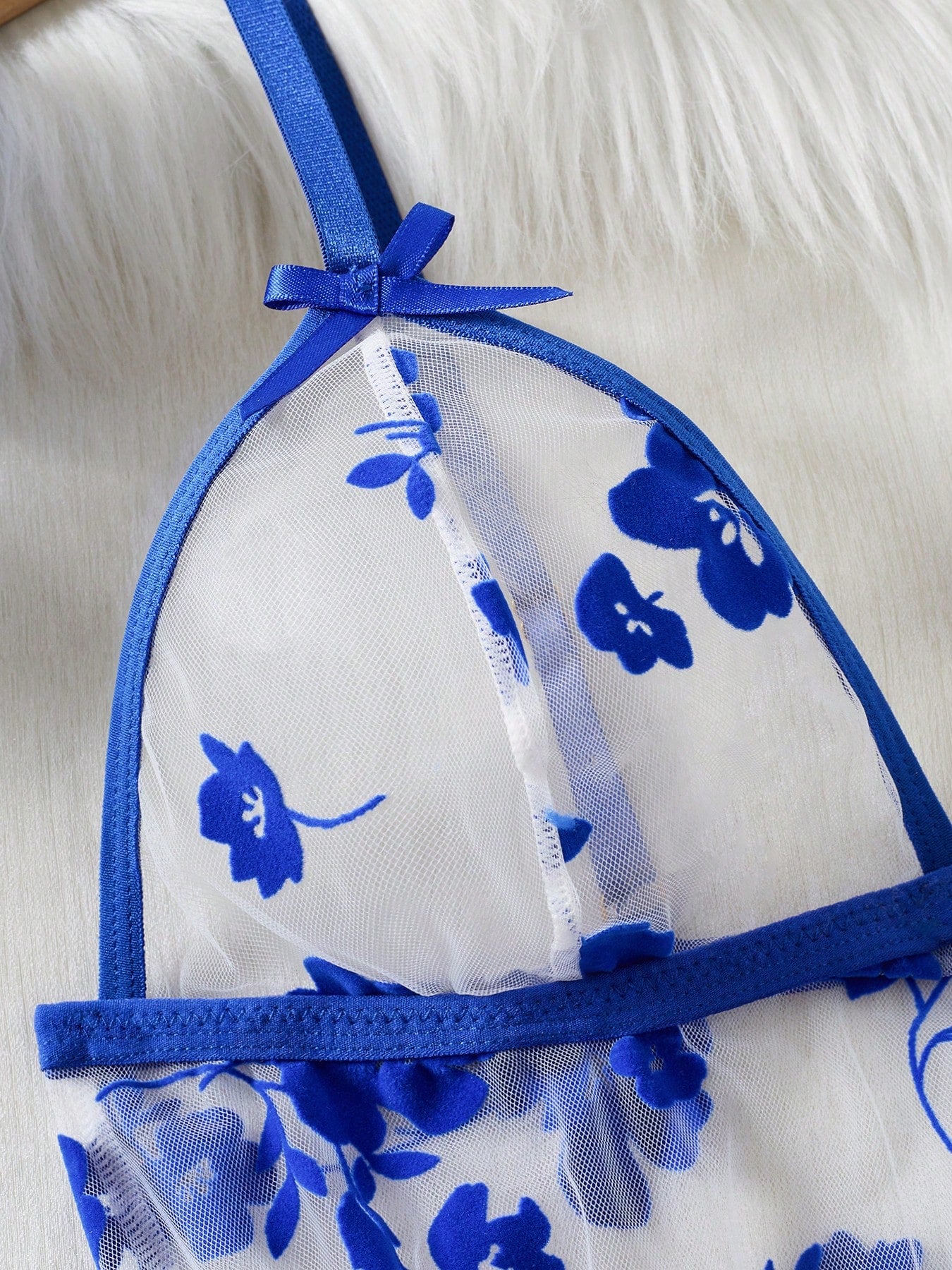 Blue 2-piece women’s lingerie set with floral print mesh and embroidery details, featuring a front-closure spaghetti strap babydoll with adjustable straps and a matching low-rise thong; semi-sheer, sleeveless, and wireless design.