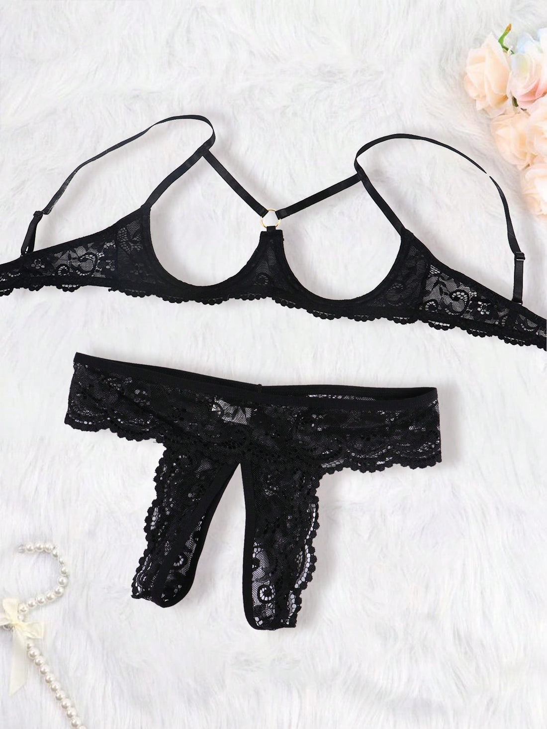 Women's black 2-piece lace lingerie set featuring a sheer wireless bralette with bowknot detail and adjustable spaghetti straps, paired with low-rise open crotch tanga thong panties.