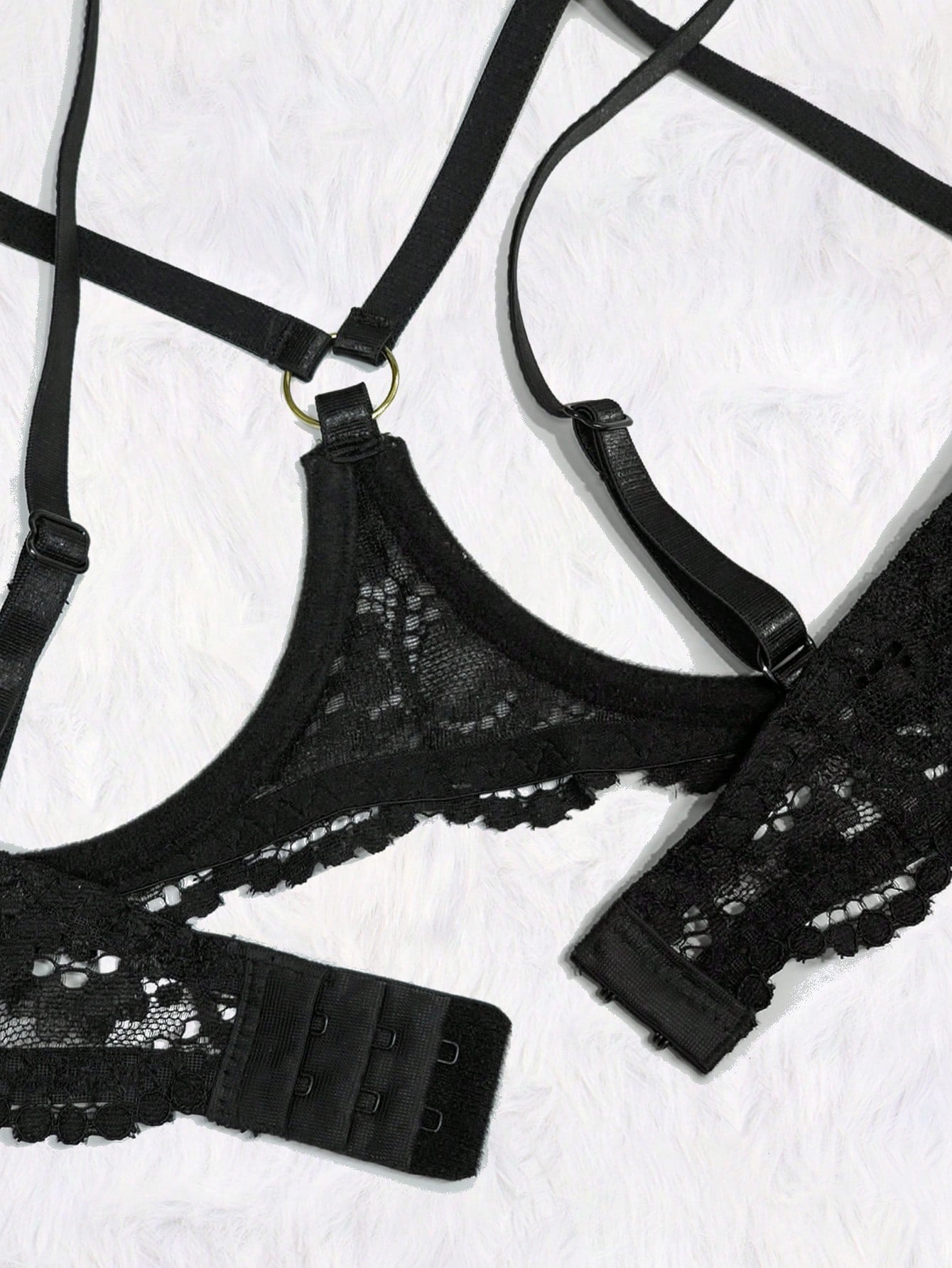 Women's black 2-piece lace lingerie set featuring a sheer wireless bralette with bowknot detail and adjustable spaghetti straps, paired with low-rise open crotch tanga thong panties.