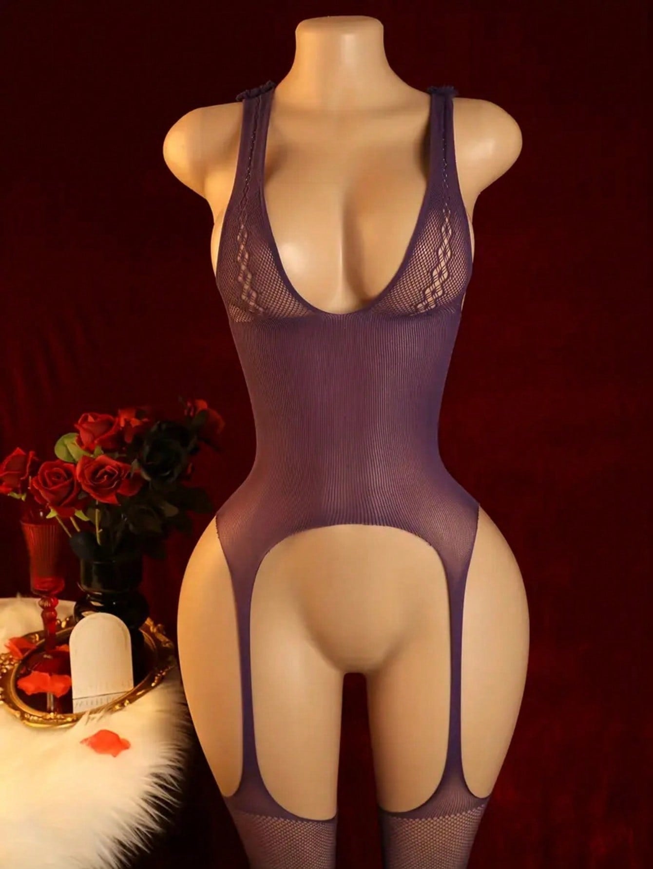 Purple semi-sheer women’s bodystocking lingerie with a plunge neckline, backless design, open crotch, hollow-out cut details, contrast mesh accents, and adjustable straps in a high-stretch polyamide and elastane blend.