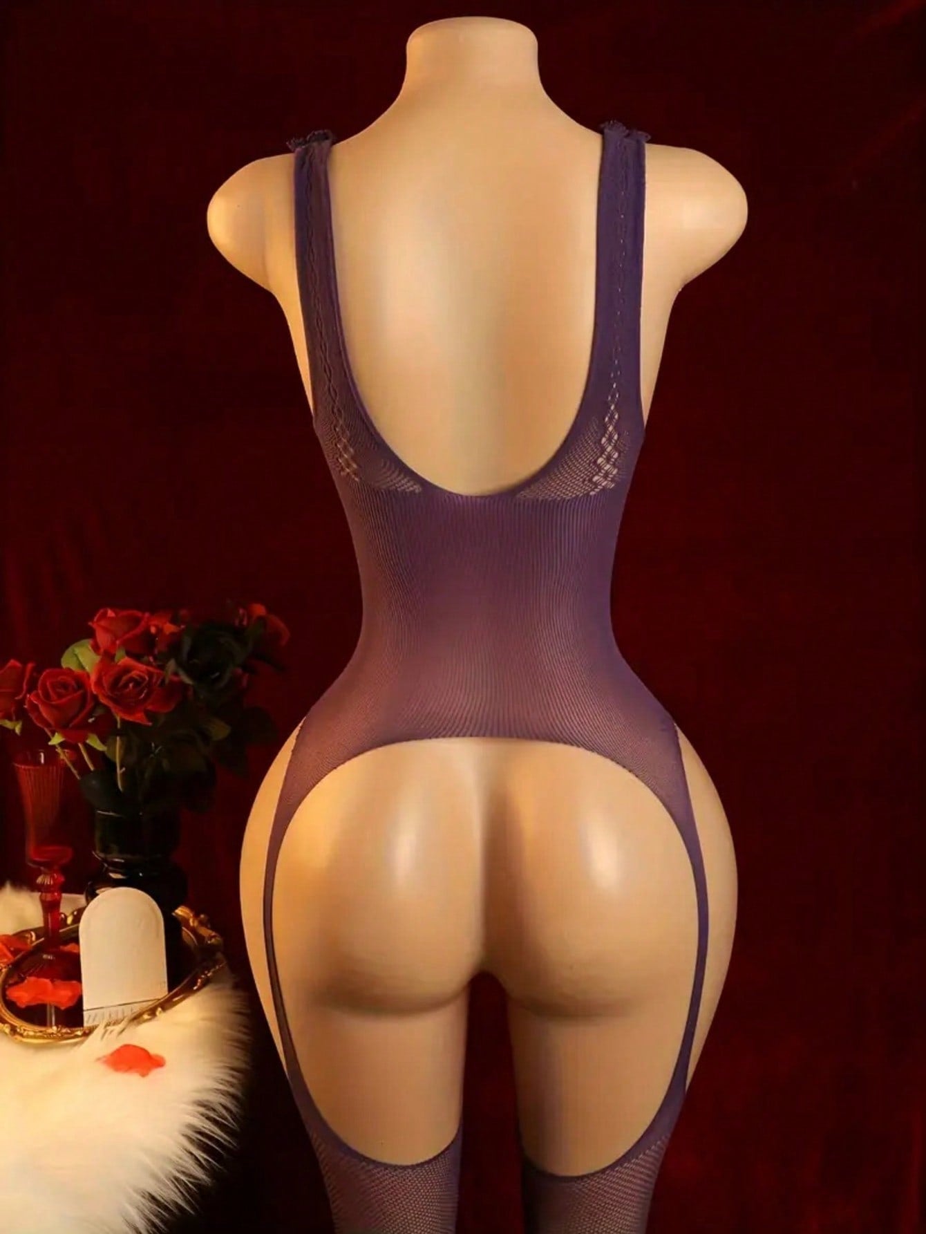 Purple semi-sheer women’s bodystocking lingerie with a plunge neckline, backless design, open crotch, hollow-out cut details, contrast mesh accents, and adjustable straps in a high-stretch polyamide and elastane blend.