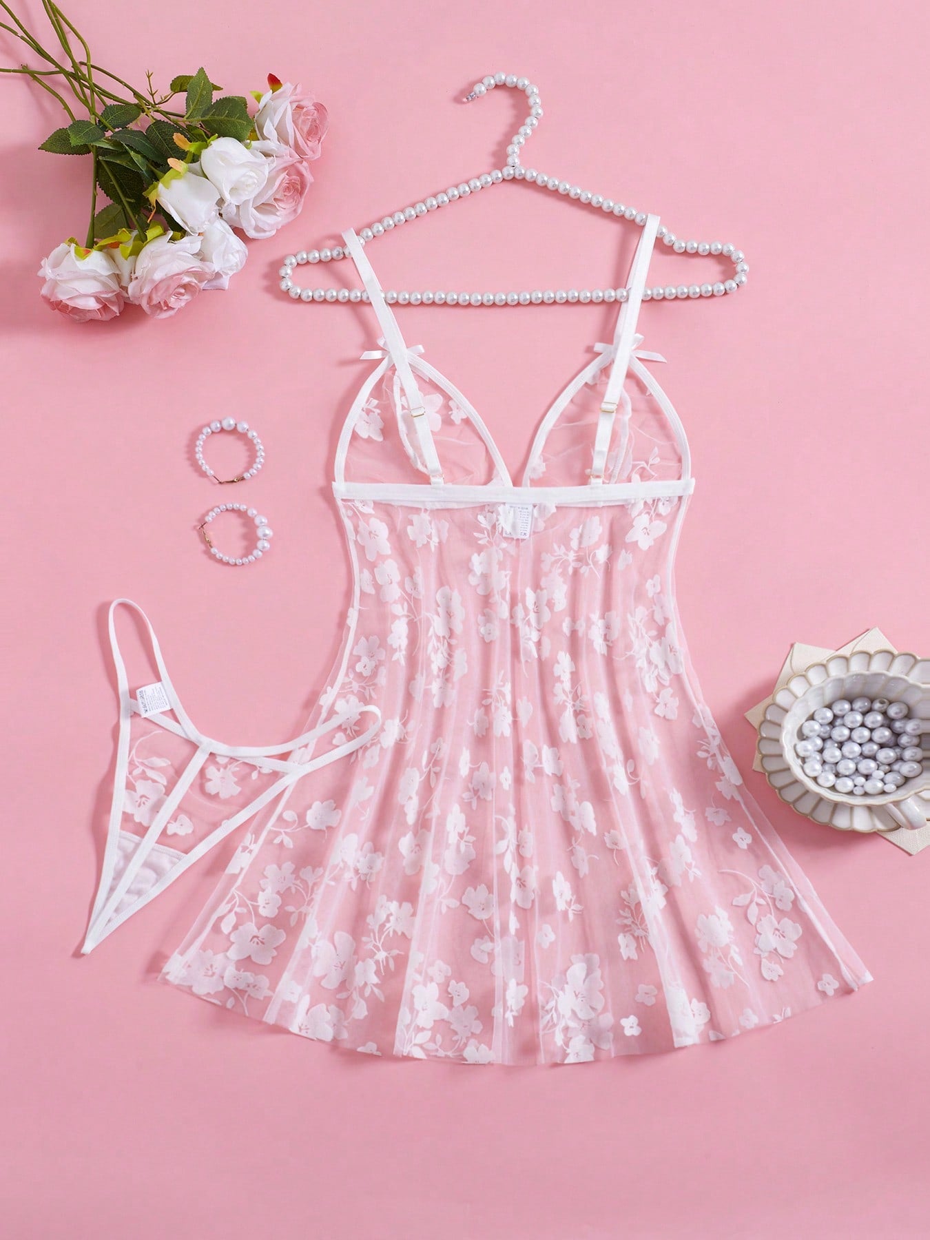 Blue 2-piece women’s lingerie set with floral print mesh and embroidery details, featuring a front-closure spaghetti strap babydoll with adjustable straps and a matching low-rise thong; semi-sheer, sleeveless, and wireless design.