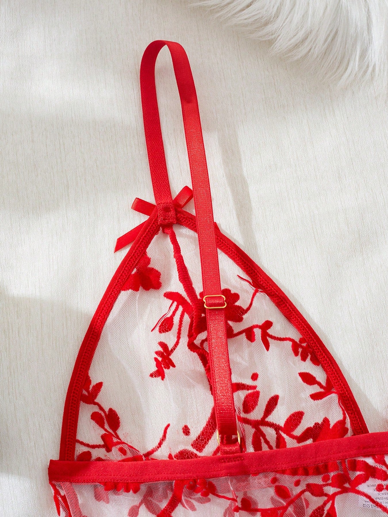 Two-piece women’s floral mesh sleepwear set featuring a front-clasp sheer embroidered bralette with adjustable spaghetti straps and a matching low-rise thong.