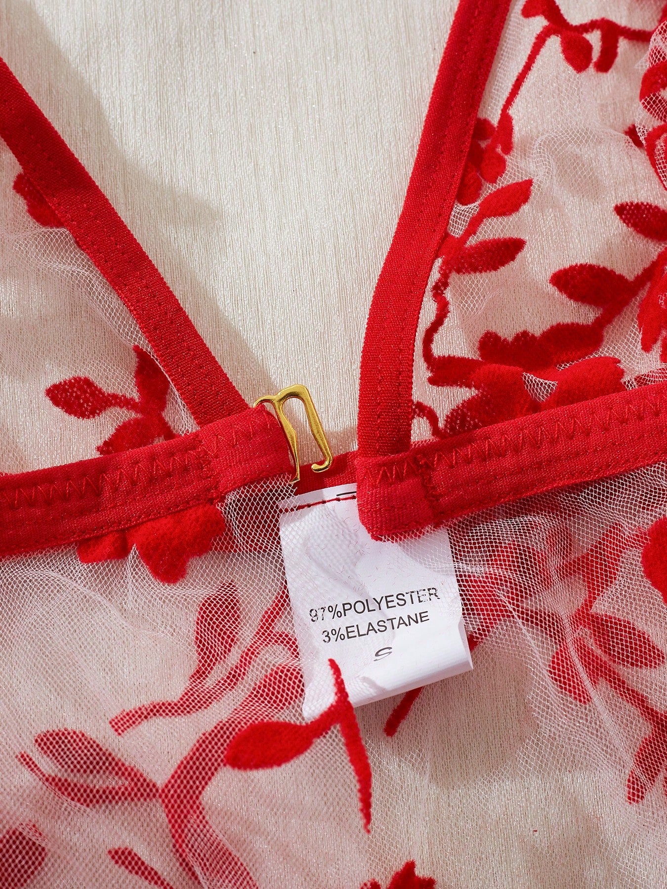 Two-piece women’s floral mesh sleepwear set featuring a front-clasp sheer embroidered bralette with adjustable spaghetti straps and a matching low-rise thong.